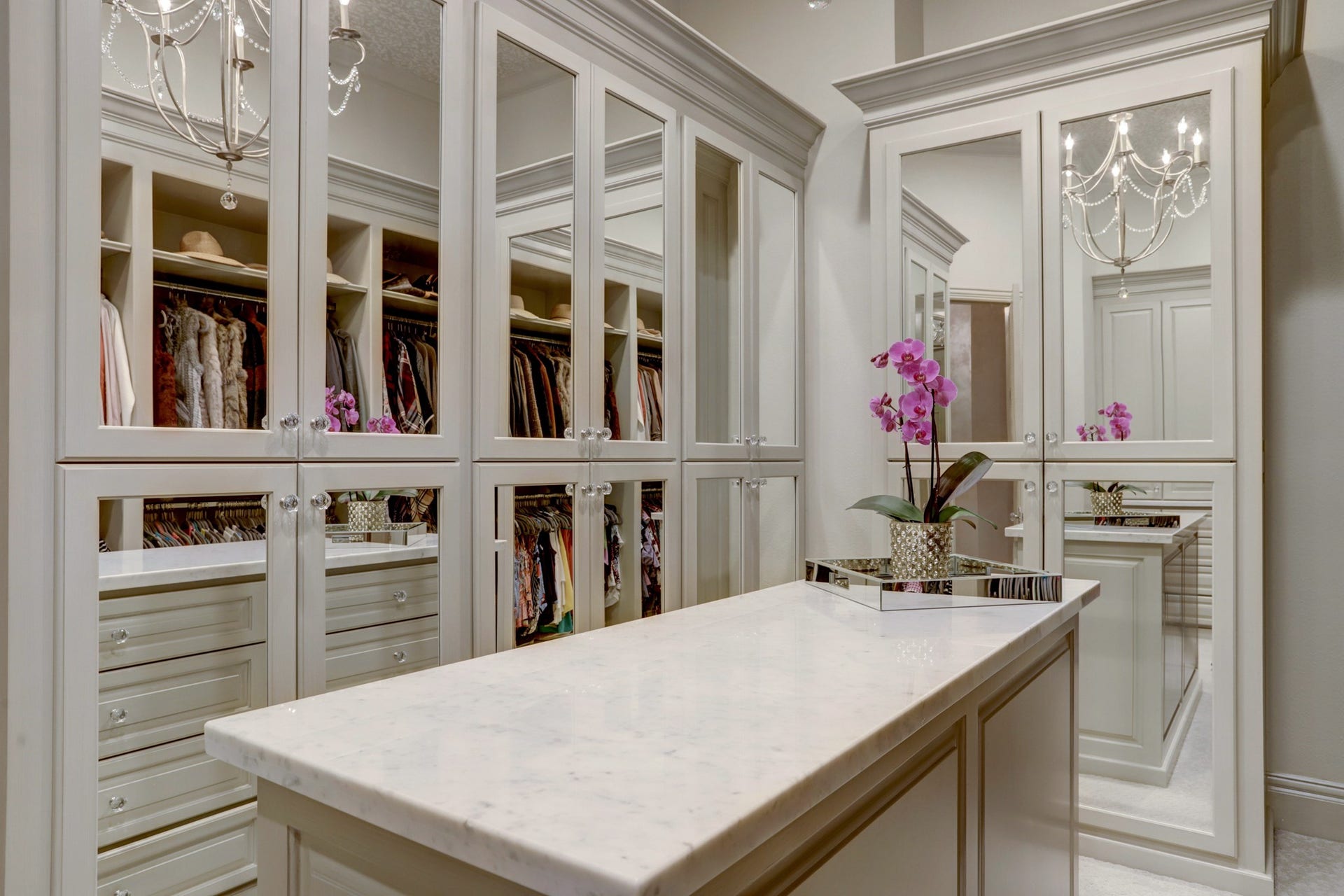 36 Saddlebrook Court, Tomball, TX 77375 Custom primary closet featuring an island and mirrored cabinetry for added elegance and storage.