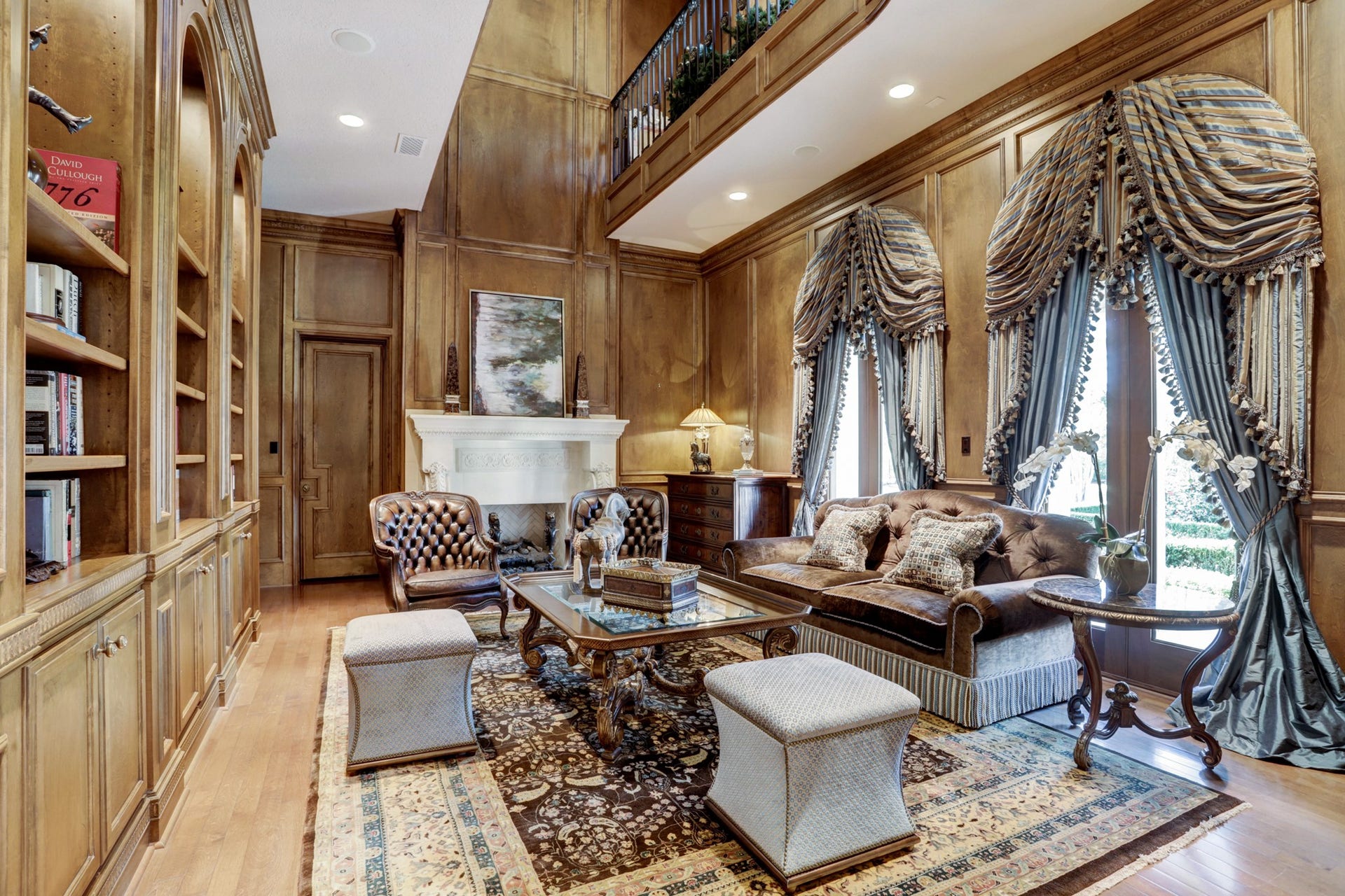 36 Saddlebrook Court, Tomball, TX 77375 Paneled study with second floor library wrapped in detailed millwork, built-ins and grand stone fireplace.