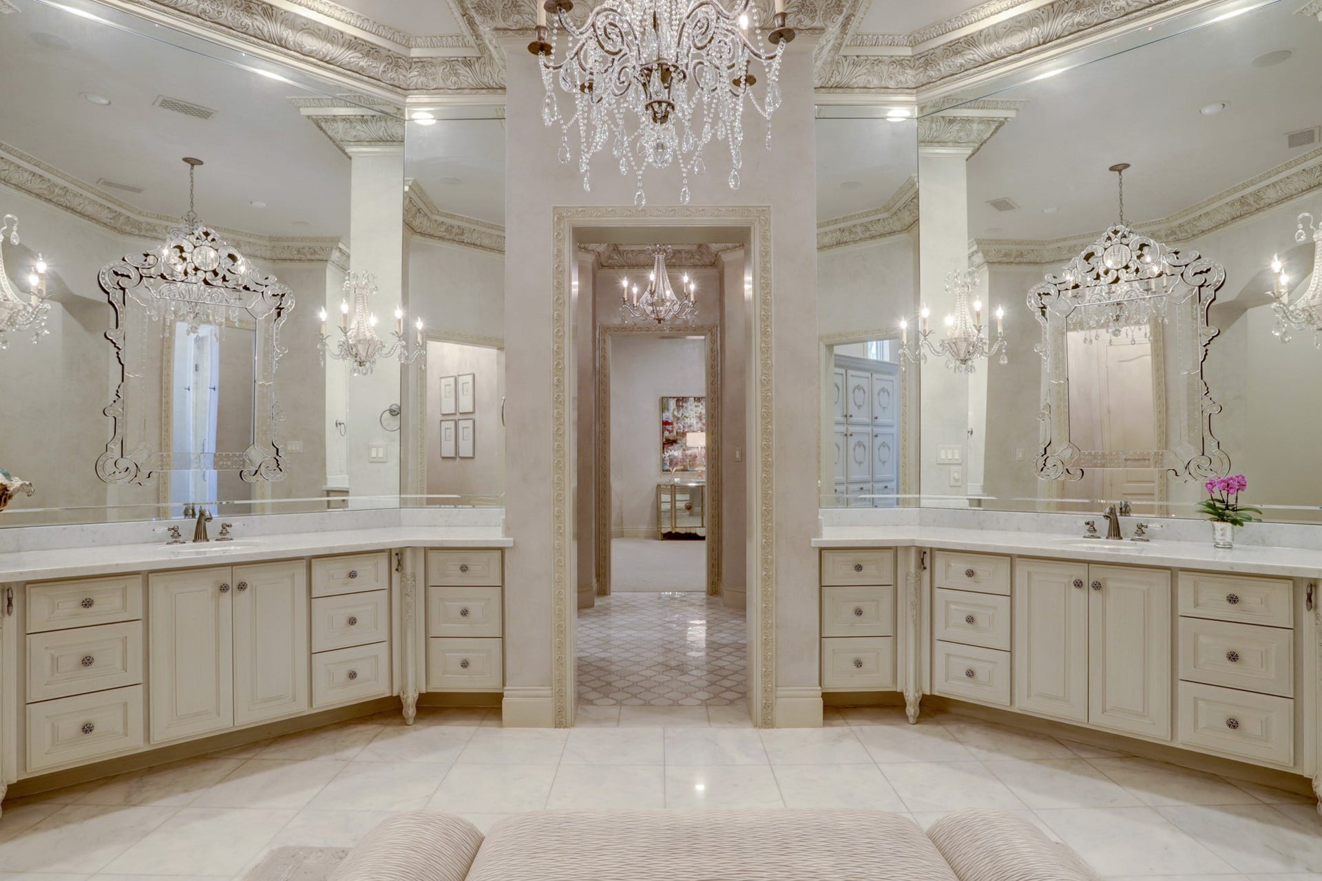 36 Saddlebrook Court, Tomball, TX 77375 Dual vanities framed by elegant, ceiling-height mirrors, marble floors, multiple chandeliers and abundant storage space.