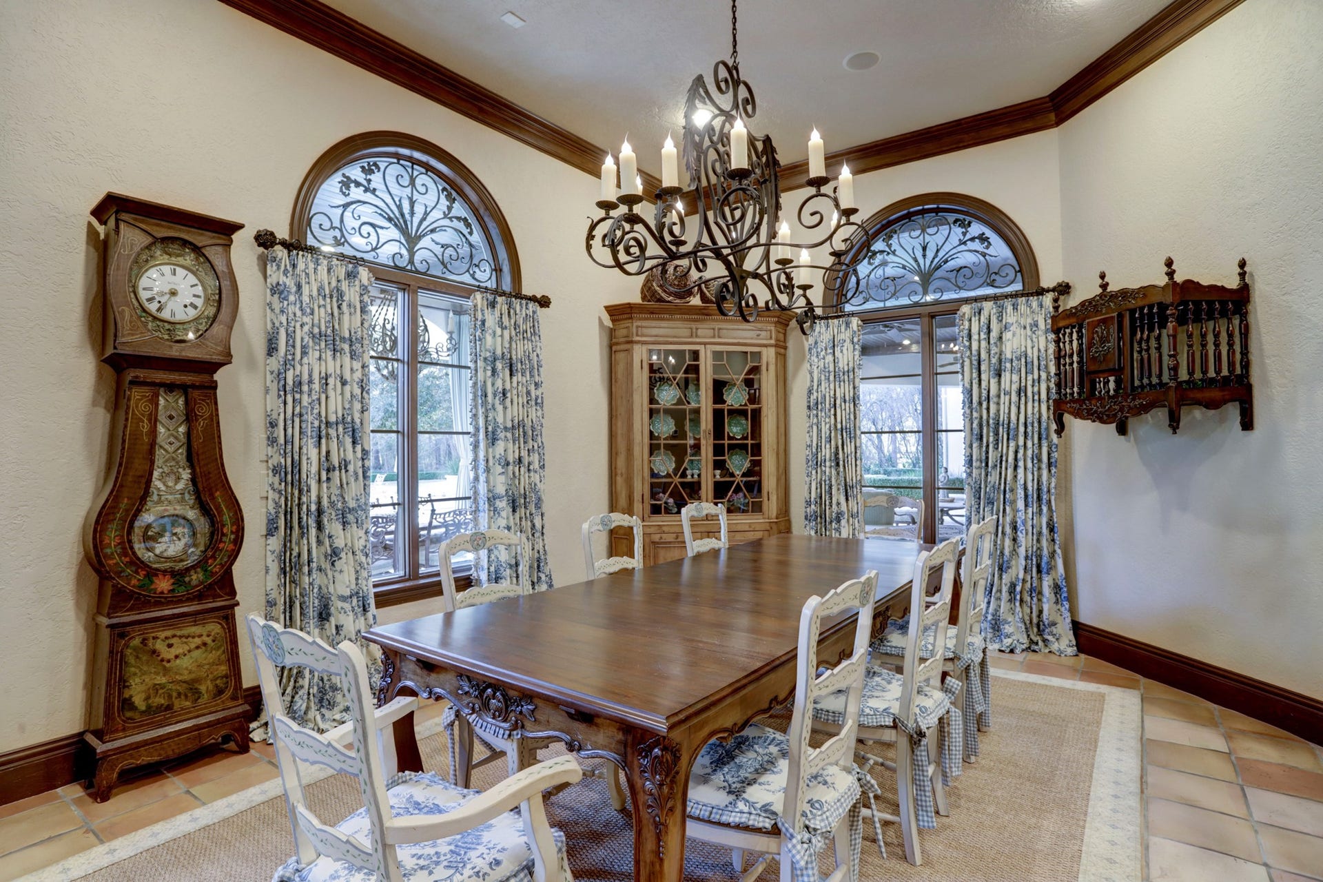 36 Saddlebrook Court, Tomball, TX 77375 Casual dining room transitions seamlessly from family room is filled with natural light, featuring authentic terra cotta tile floors, crown molding, and an elegant chandelier.