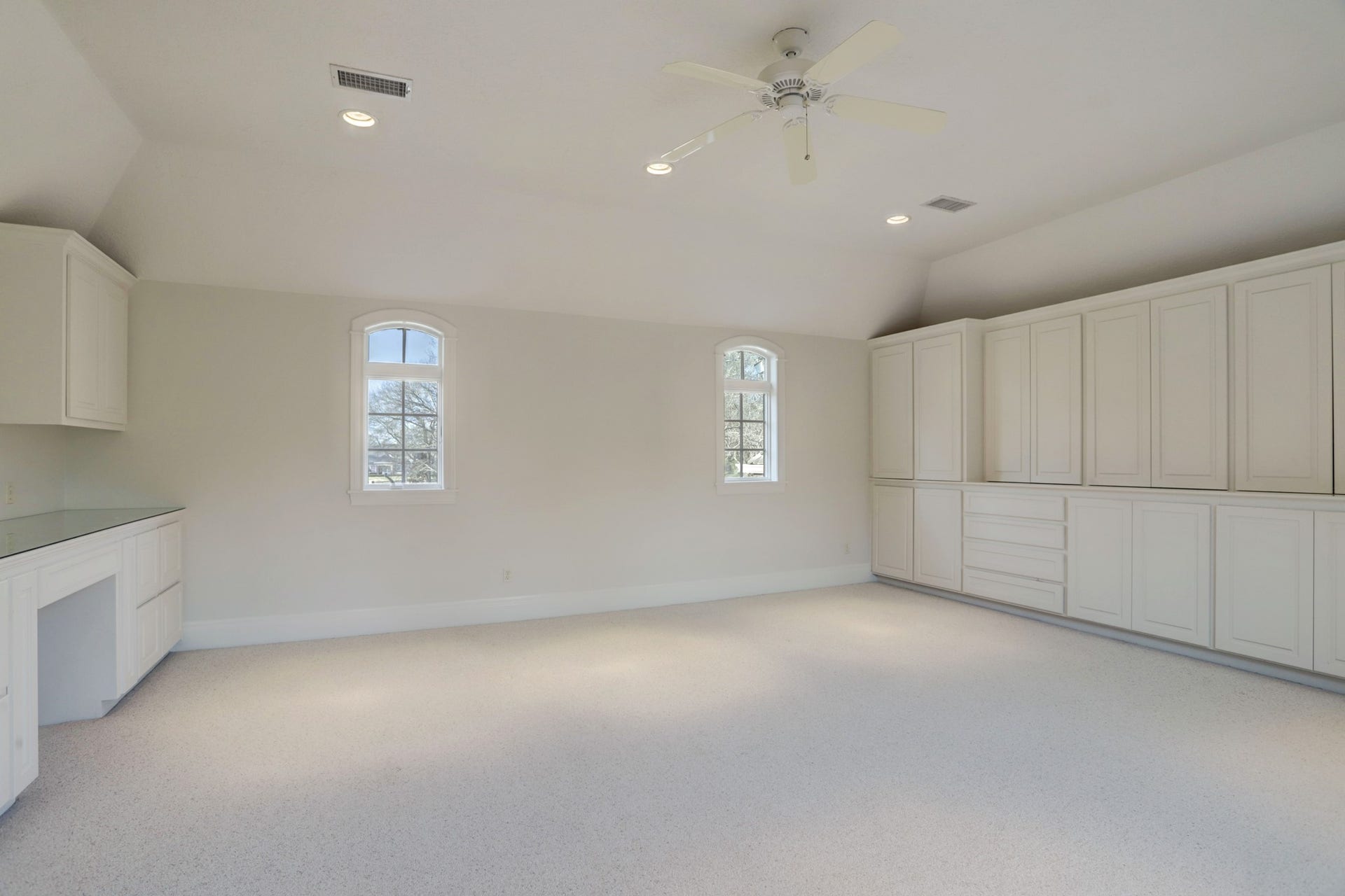 36 Saddlebrook Court, Tomball, TX 77375 The 4-car garage features a dedicated workshop area, ample storage, and pristine epoxy floors, with convenient access via the motor court.