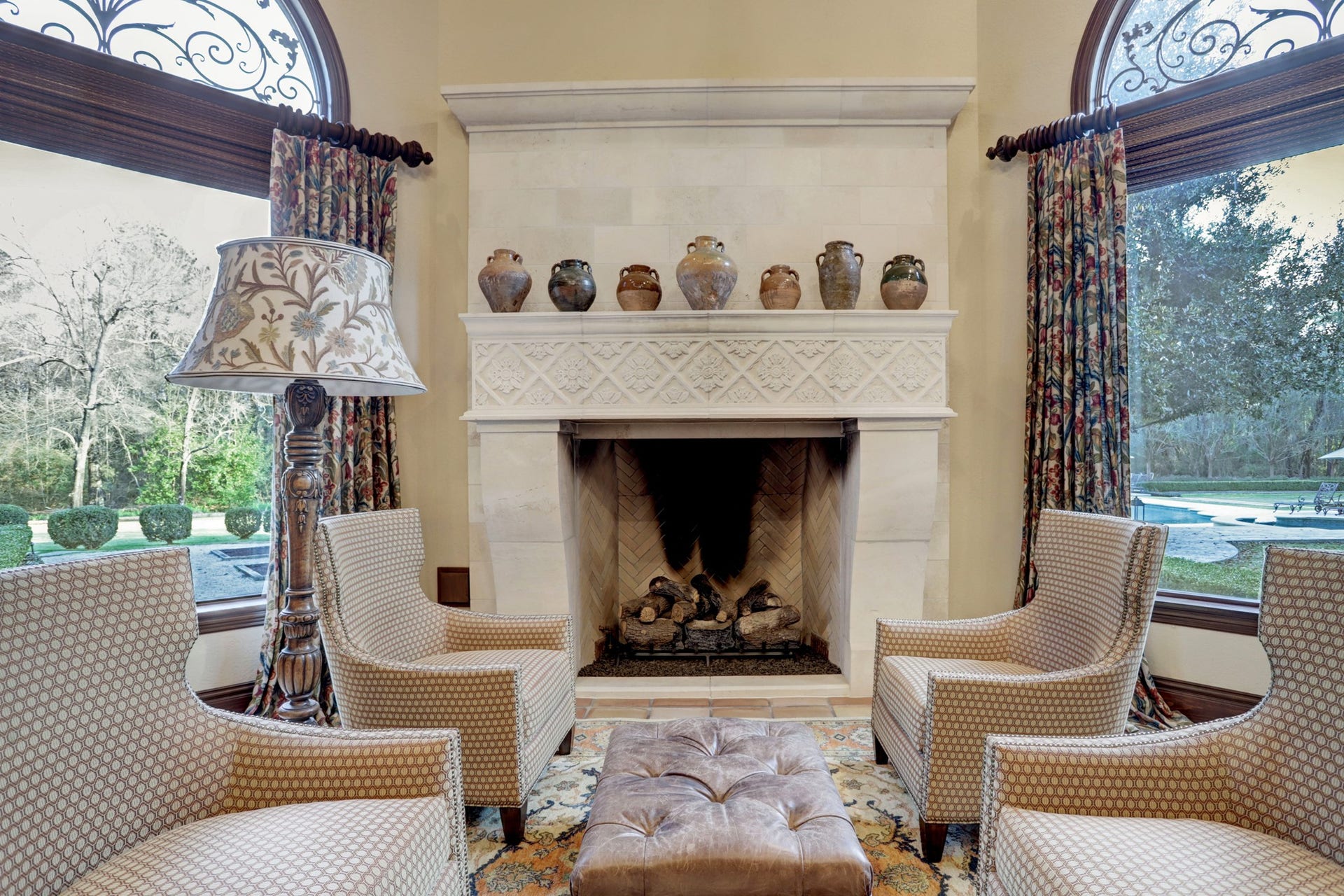 36 Saddlebrook Court, Tomball, TX 77375 True limestone grand fireplace in family room flanked by wall of windows with view to the gorgeous gardens and extensive landscaped grounds.