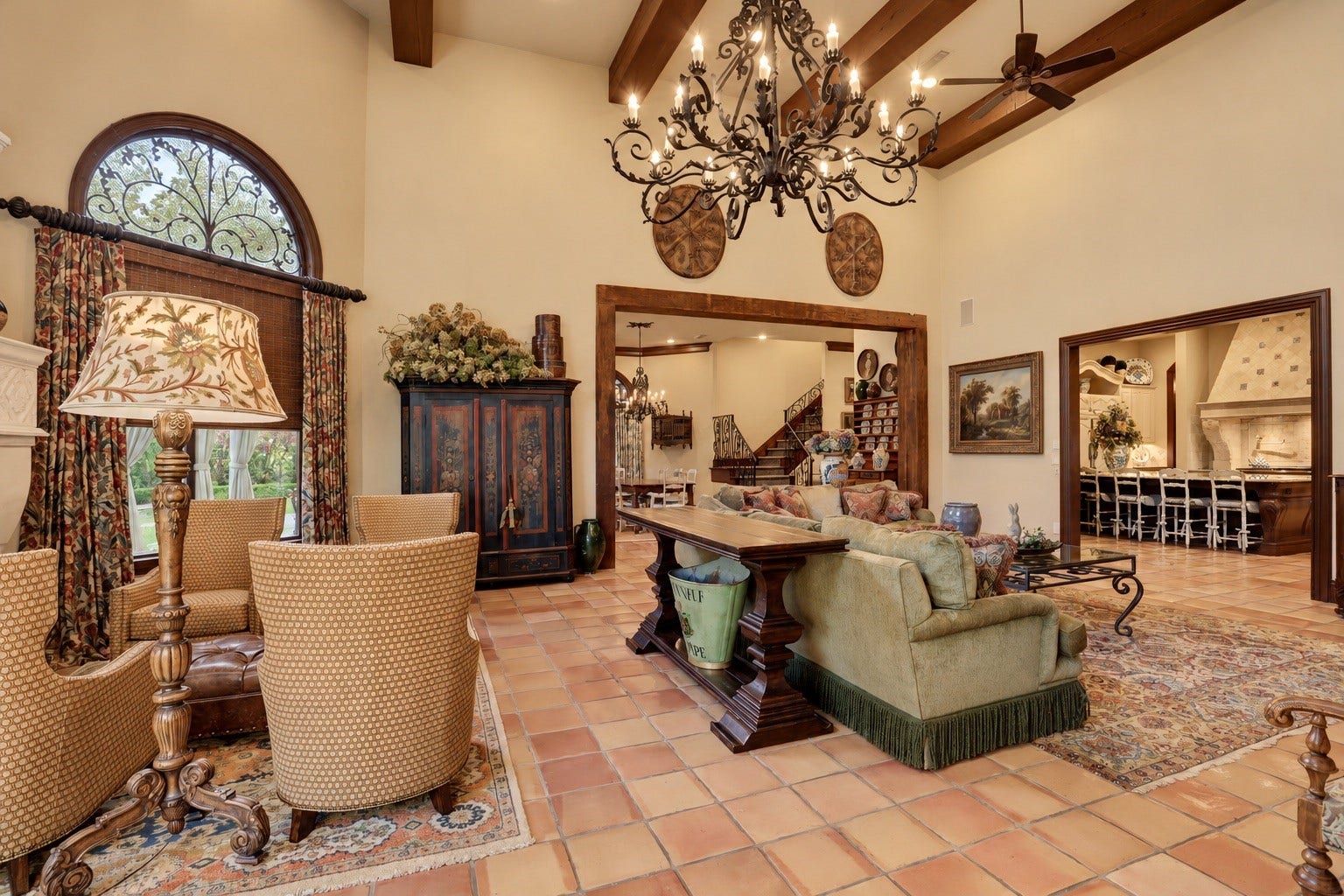 36 Saddlebrook Court, Tomball, TX 77375 Oversized family room with reclaimed wood beams, high ceilings, continued terra cotta tile floors, grand stone fireplace and livable flow from kitchen to breakfast rooms.