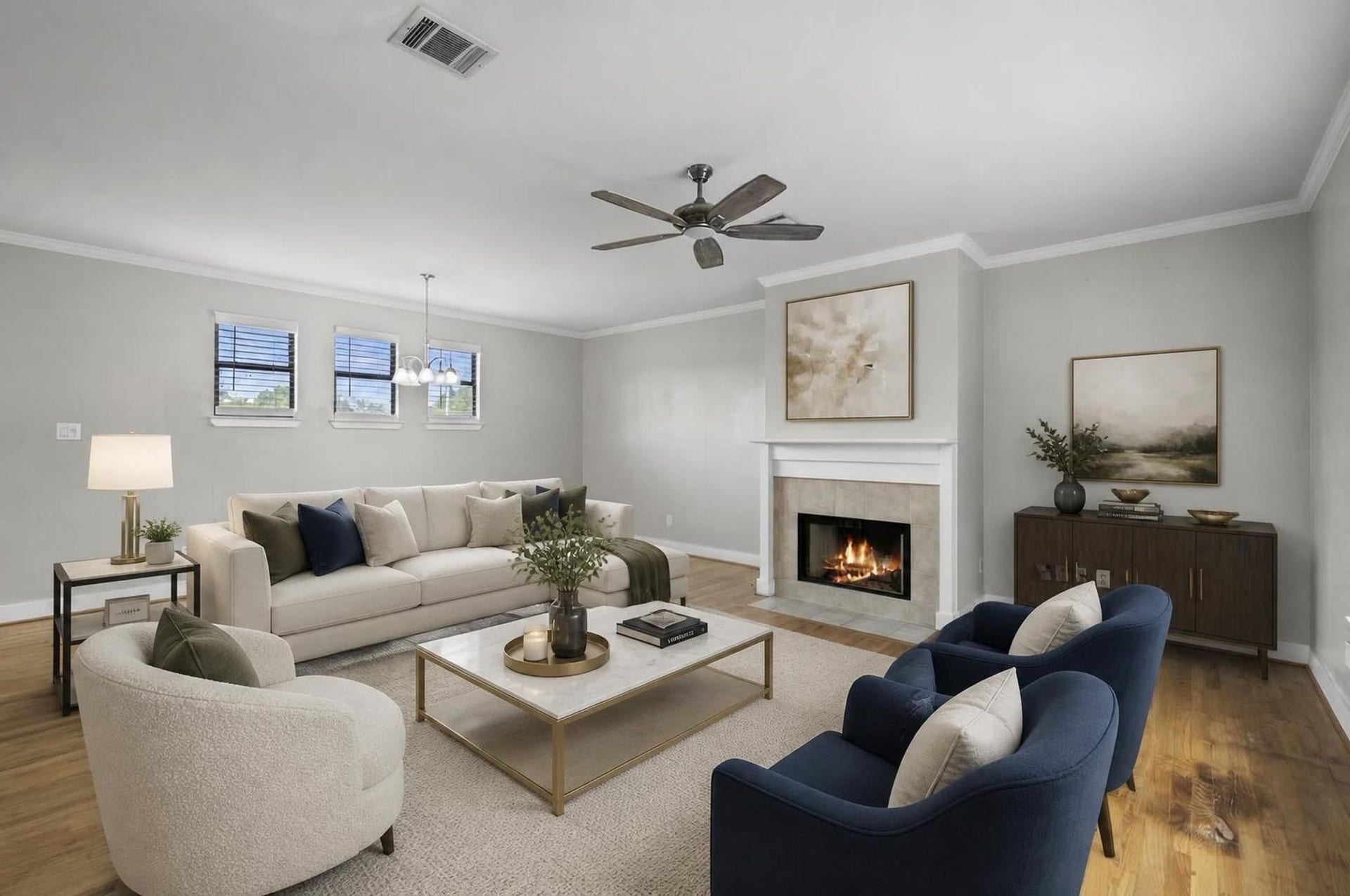 2154 Arabelle Street, Houston, TX 77007 The living room opens on the second floor with wood flooring, high ceilings, crown molding, and a gaslog fireplace that anchors the space. It feels bright, refined, and comfortable without losing its sense of warmth. Virtually staged.