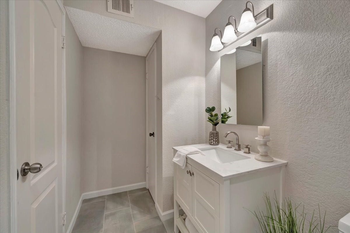 On the opposite side, enjoy the added comfort of a convenient linen closetperfect for extra storage in this tastefully designed space.