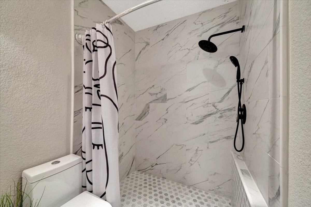 Neutral tones and contemporary materials come together to create a stylish and inviting bathroom that complements any lifestyle.