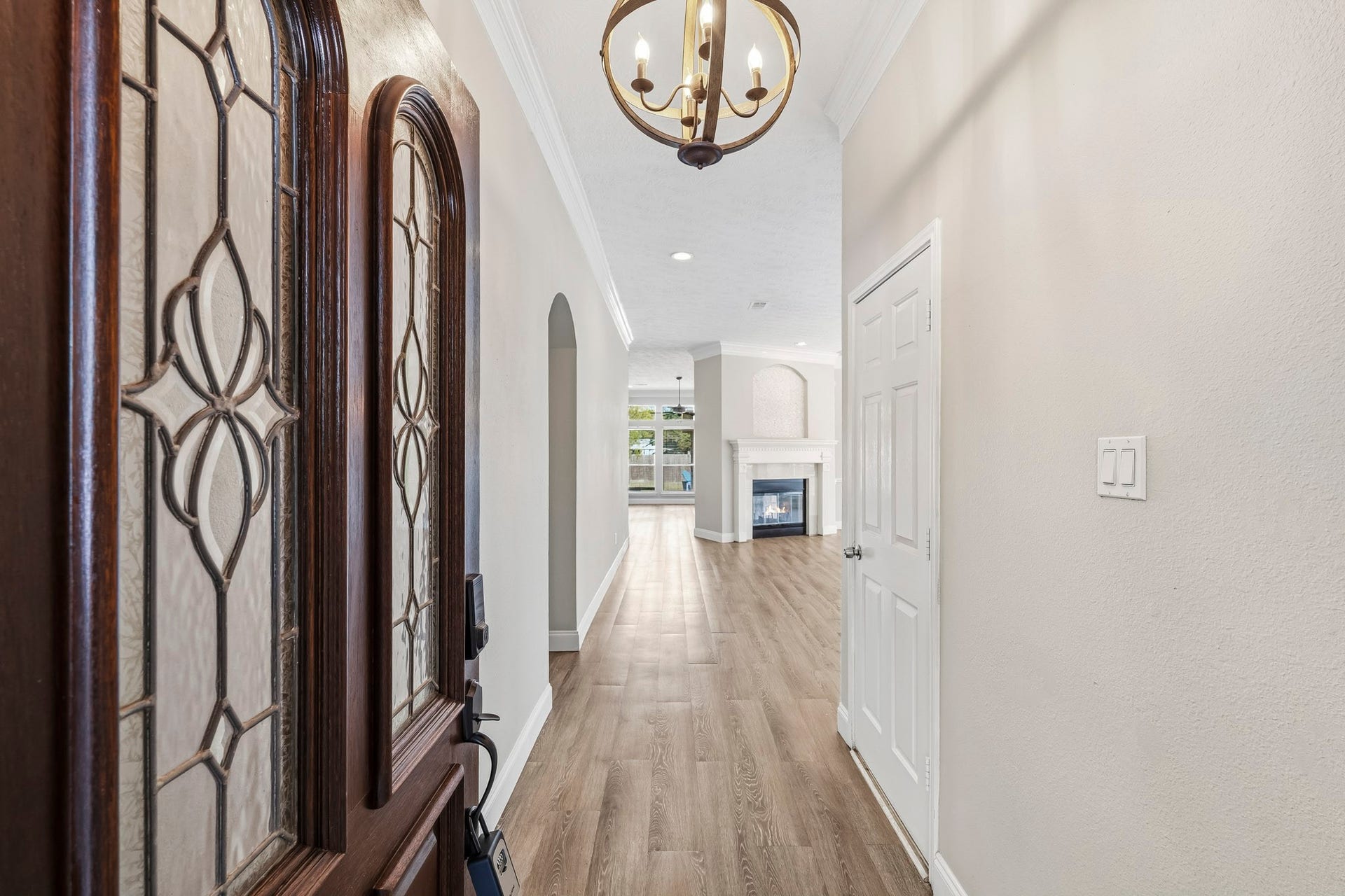 A welcoming entry introduces the home's warm neutral tones and beautiful wood-look flooring.