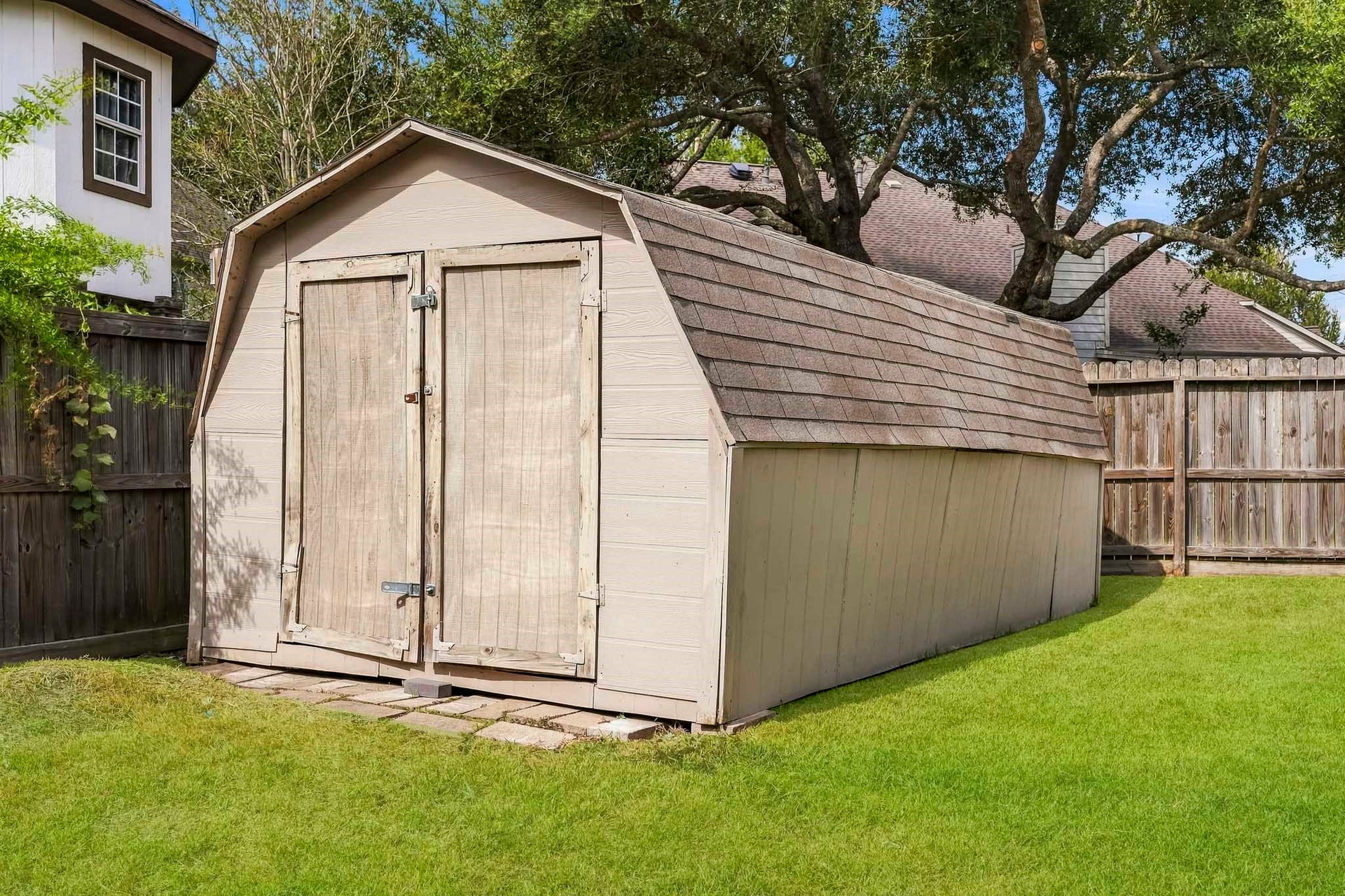 Backyard storage shed offers additional space for lawn equipment, tools, and outdoor essentials.