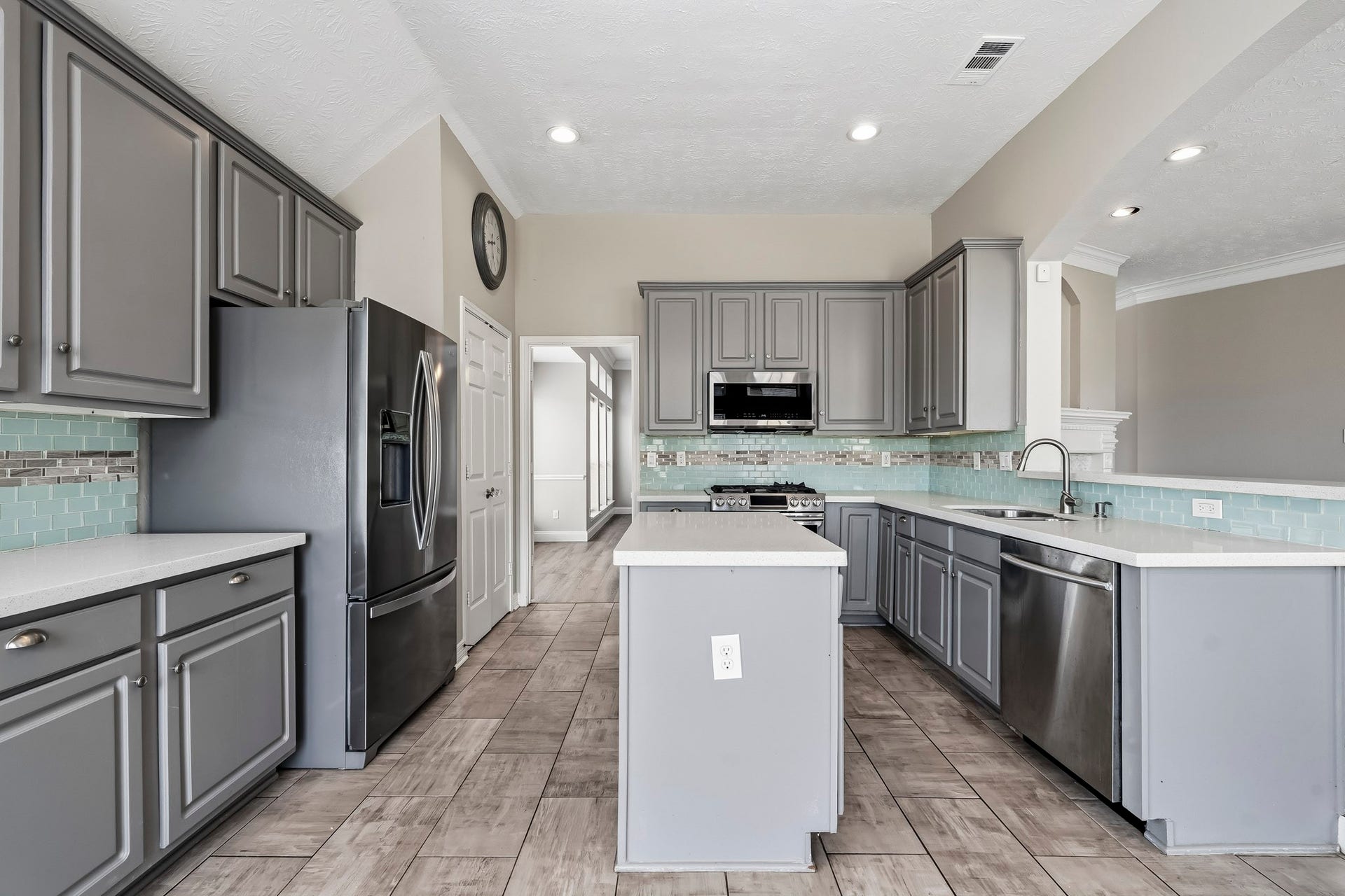 Stylish cabinetry, beautiful countertops, and generous workspace make this kitchen both functional and inviting.