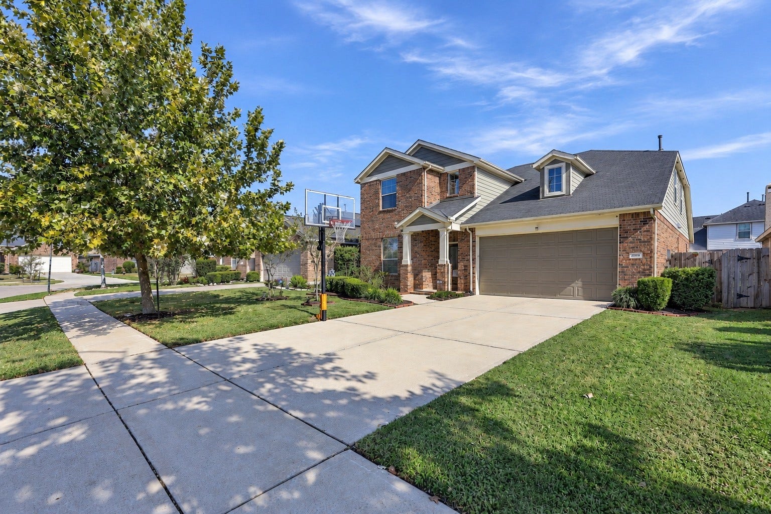This charming home offers beautiful curb appeal with mature trees, a spacious driveway and two car garage to complete this inviting exterior!