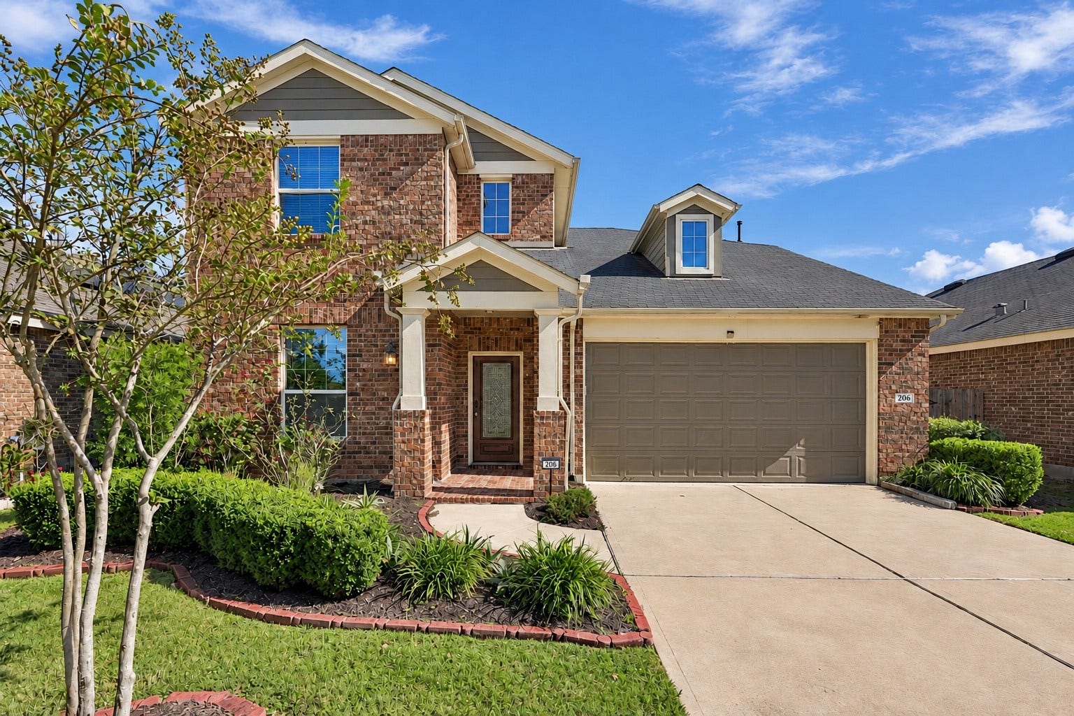 Welcome home to this beautiful two story brick residence featuring charming curb appeal and thoughtfully maintained landscaping.
