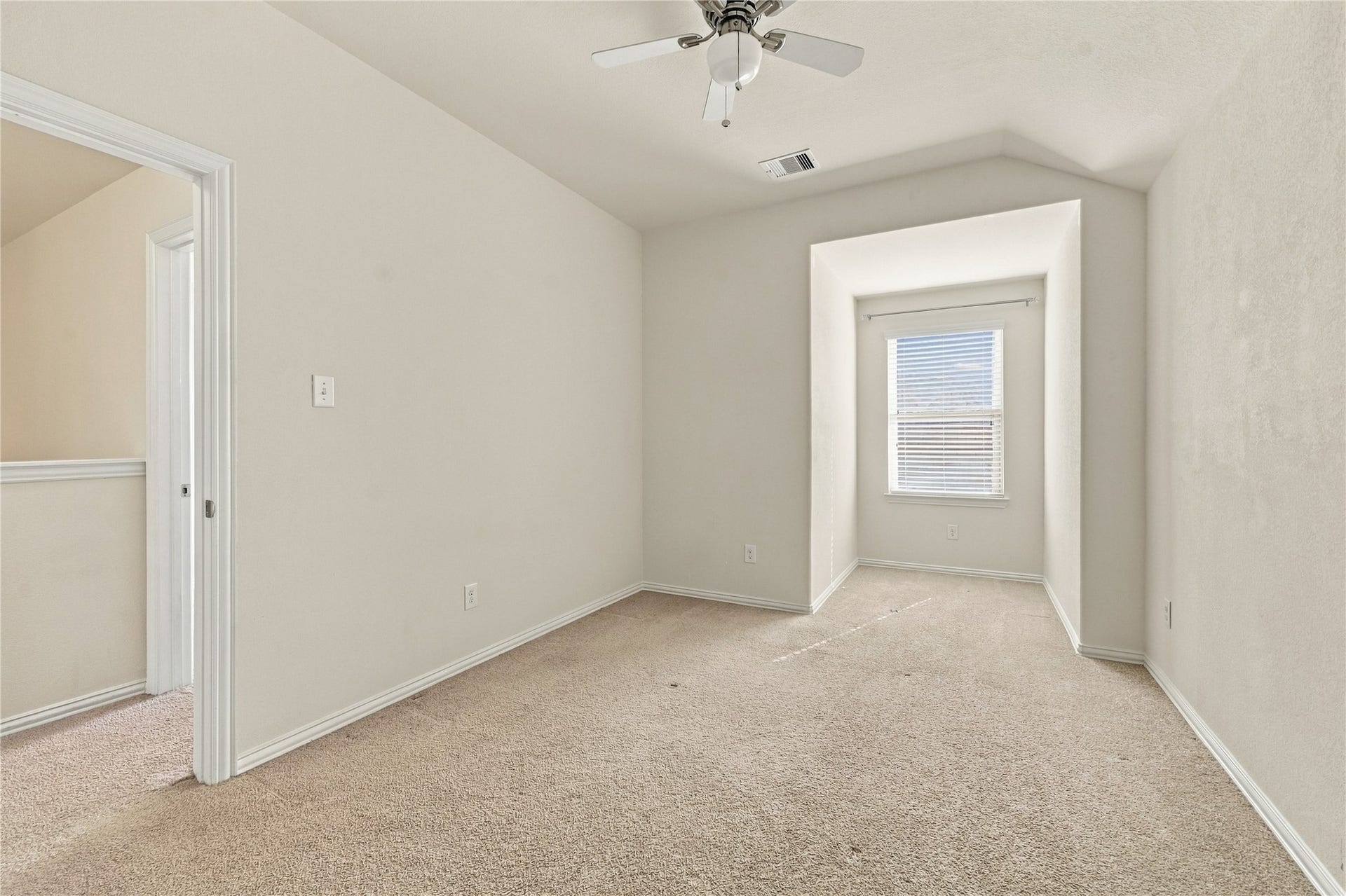 This cozy second upstairs bedroom offers a versatile layout with a charming window nook, perfect for a study area, workspace, or reading retreat!