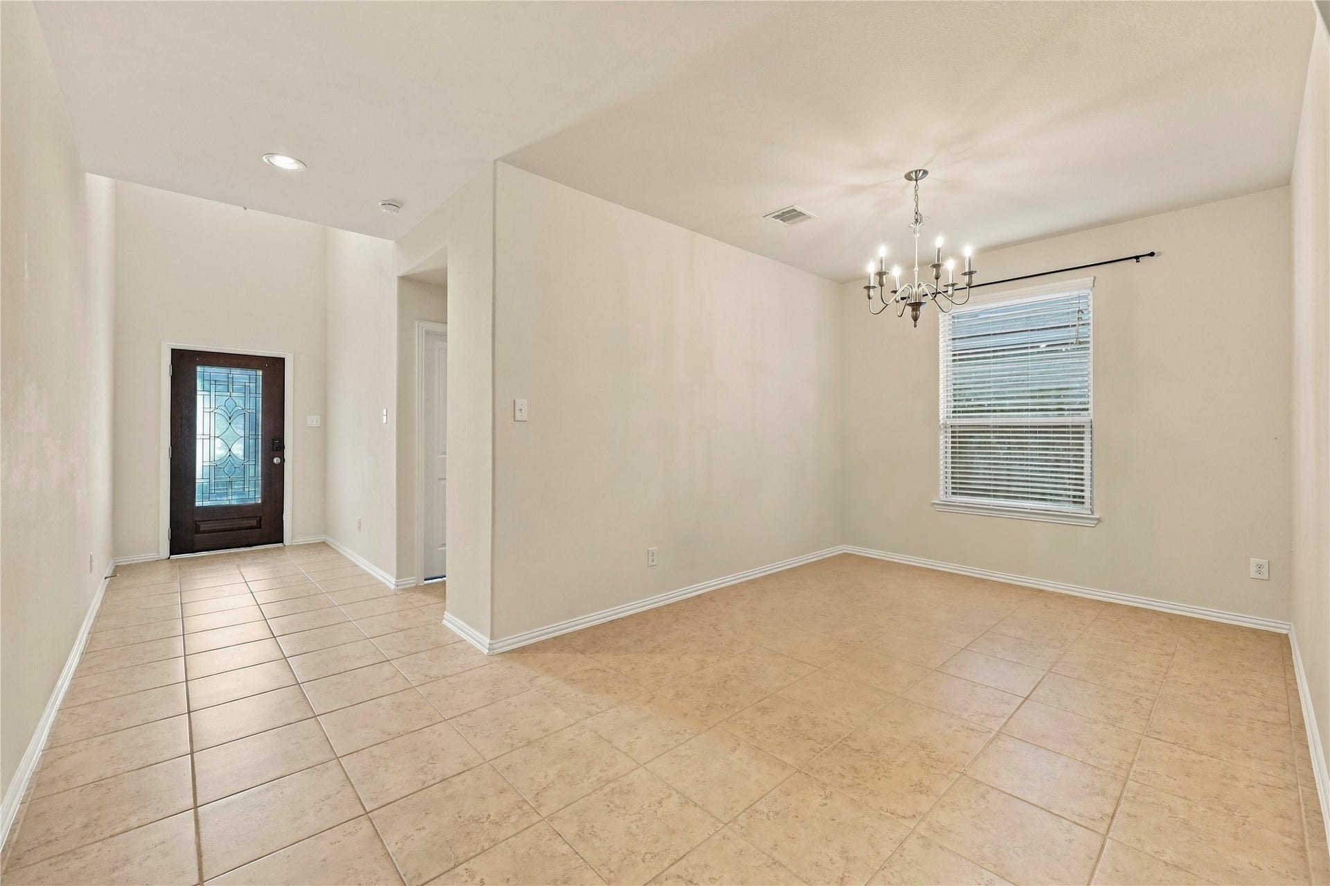A bright and welcoming entryway flows seamlessly into a spacious formal dining area, perfect for hosting gatherings.