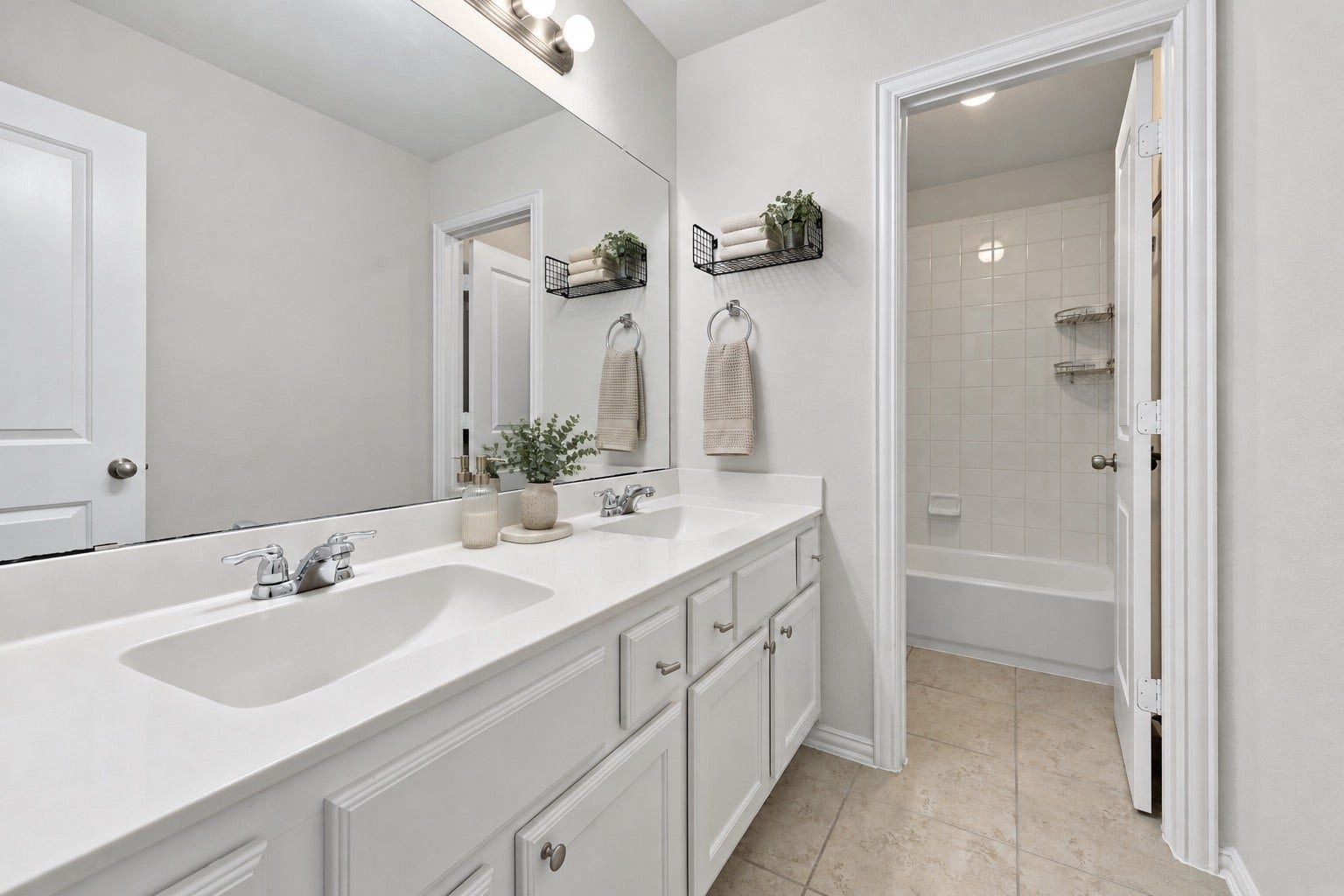 The upstairs bathroom features a spacious double sink vanity with ample storage, a large mirror, and a separate tub and shower area for added convenience!