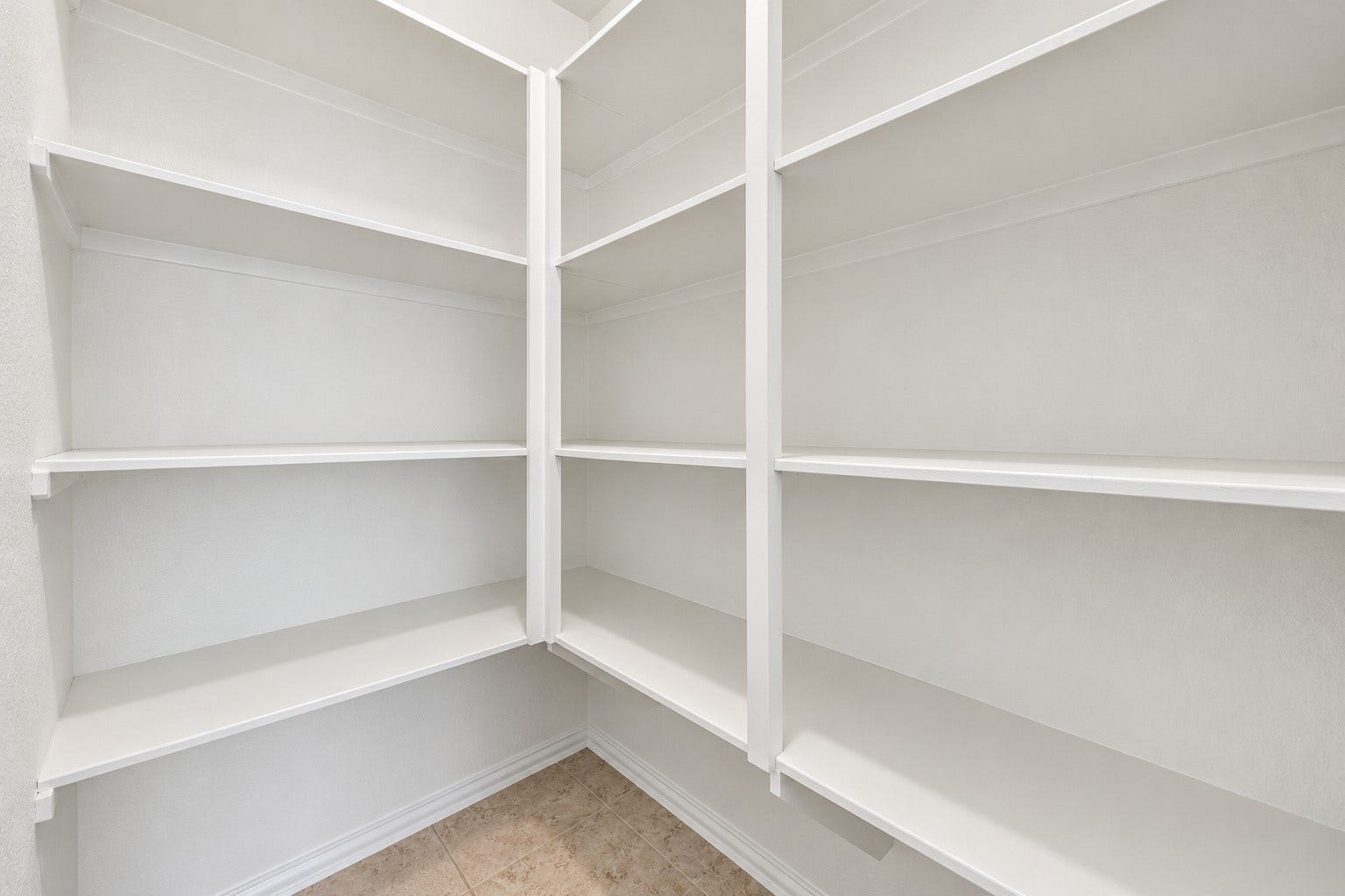 Spacious corner pantry with plenty shelf storage!