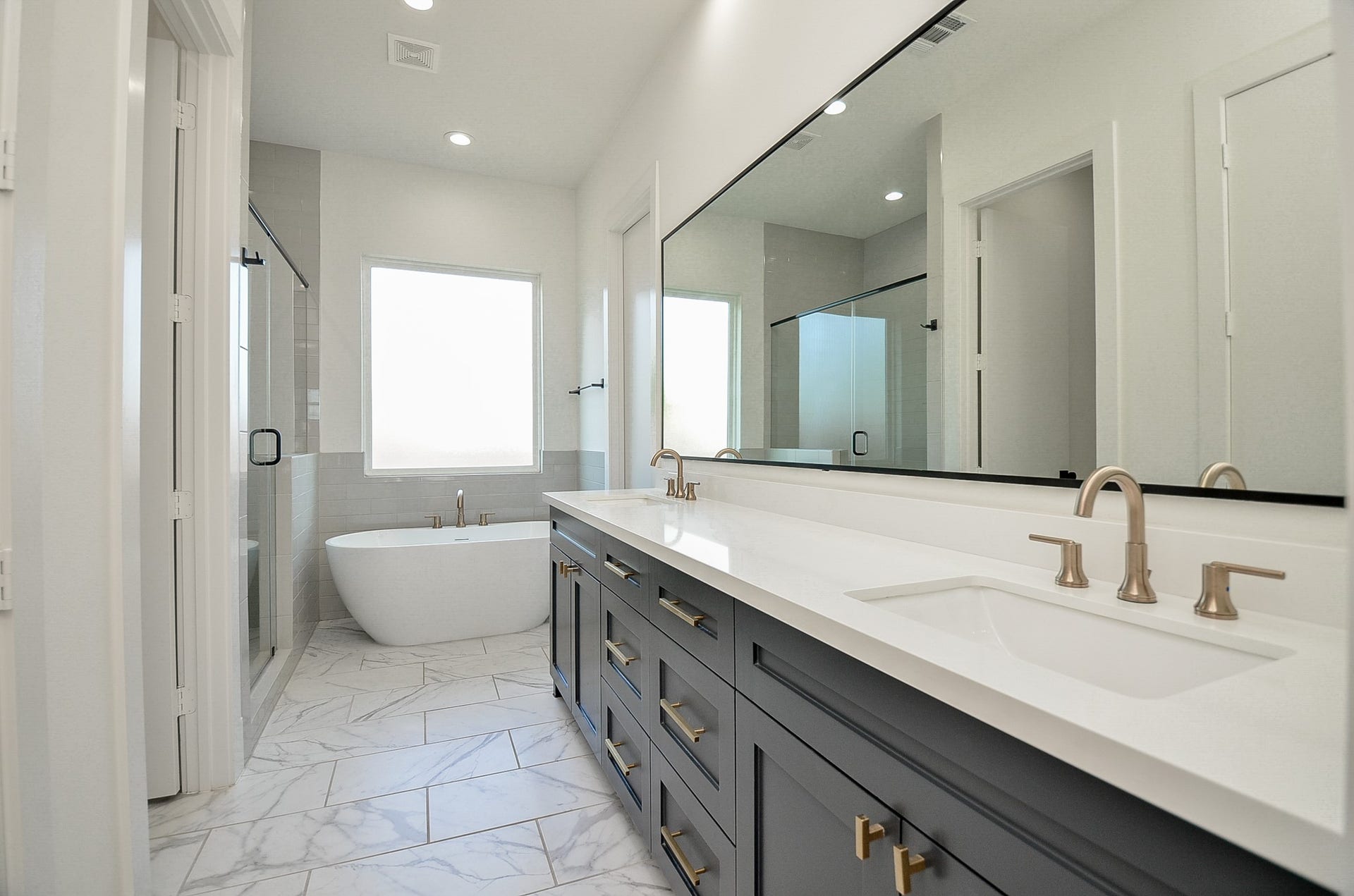 204 Burr Street, #G, Houston, TX 77011 The primary bath includes dual sinks and an extended vanity provide counter space and storage.