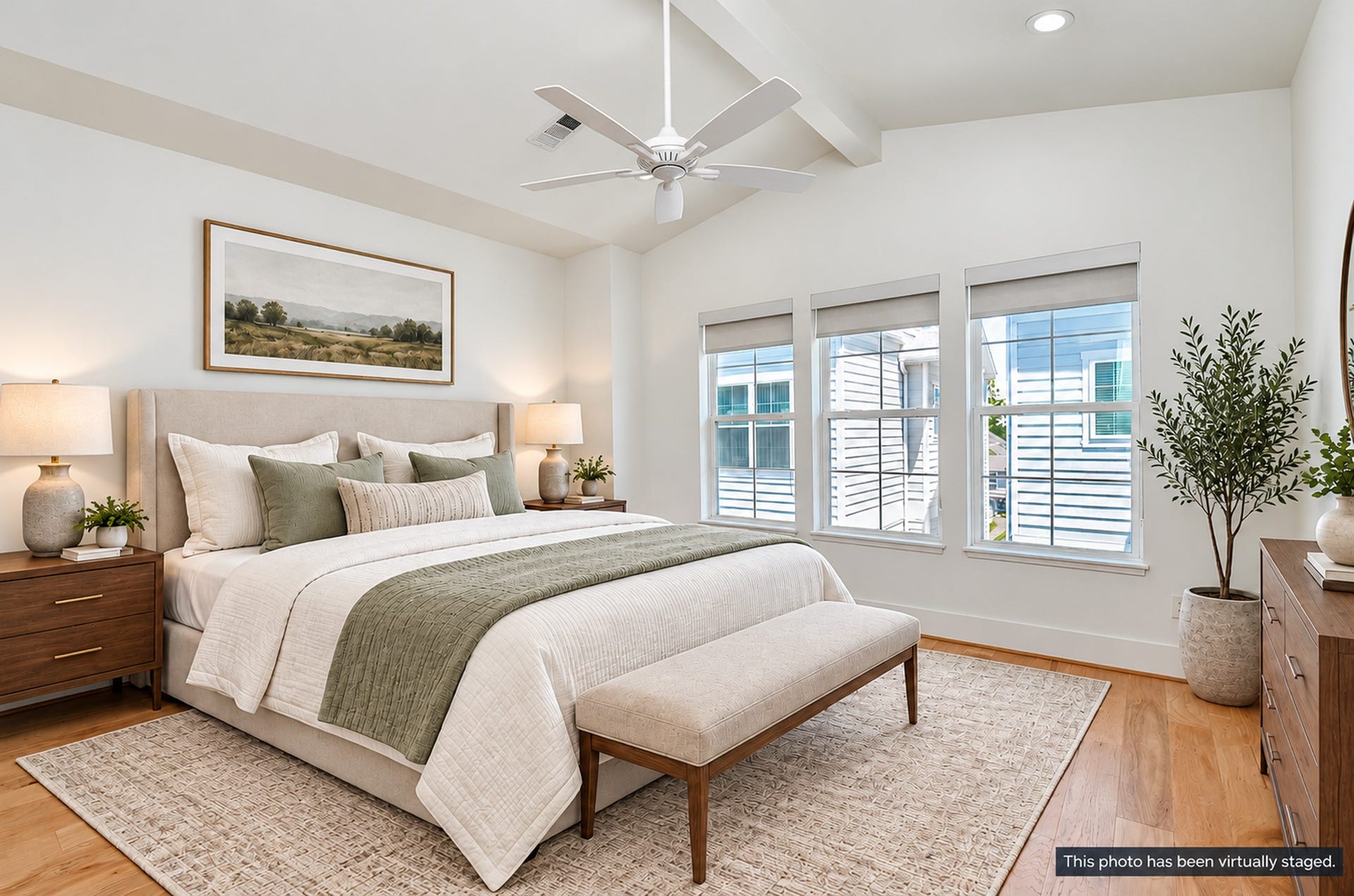 204 Burr Street, #G, Houston, TX 77011 Third-floor primary suite with vaulted ceilings and wood flooring.