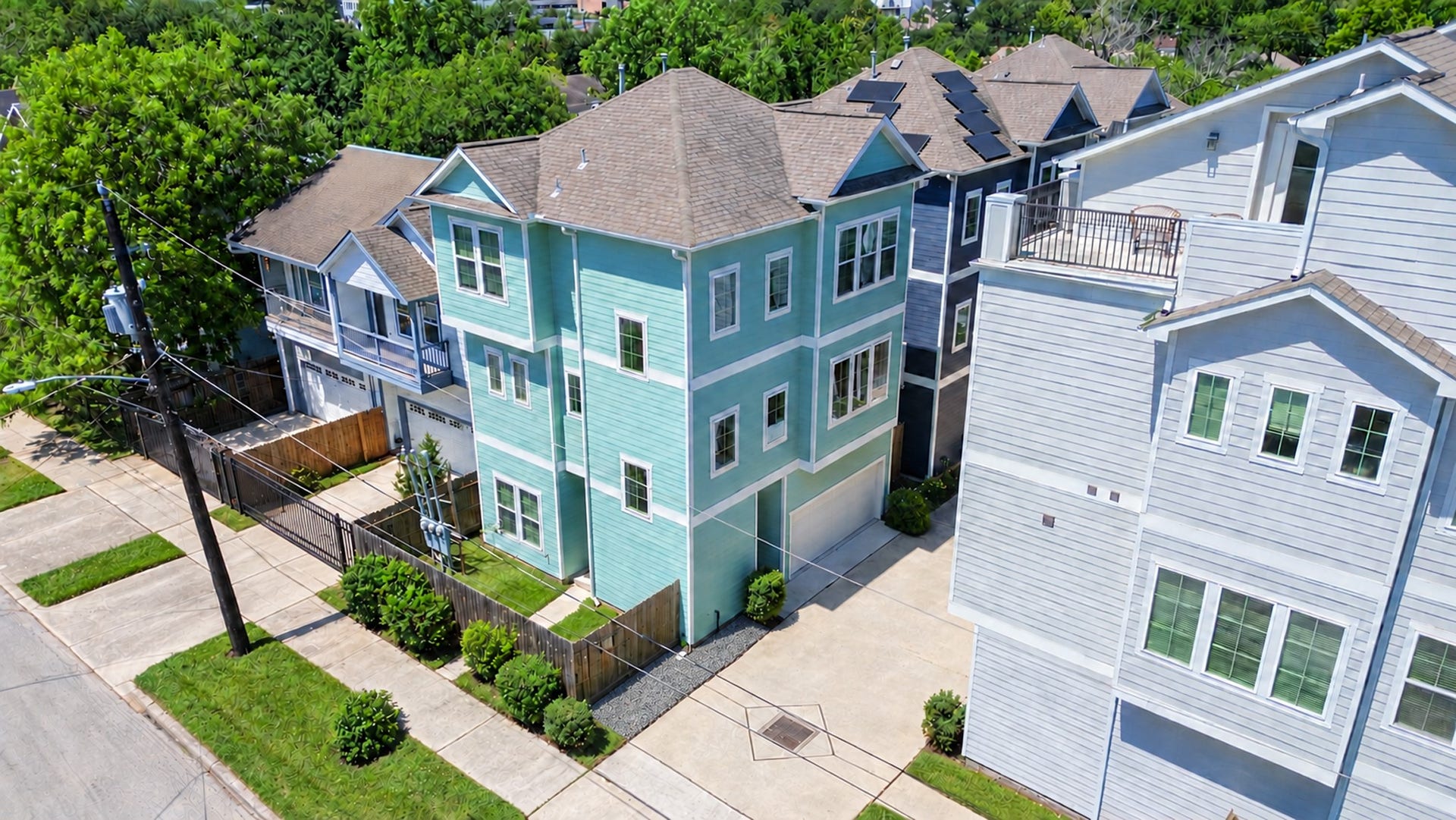 204 Burr Street, #G, Houston, TX 77011 Freestanding corner home at the community entrance, with an attached two-car garage and private fenced yard.