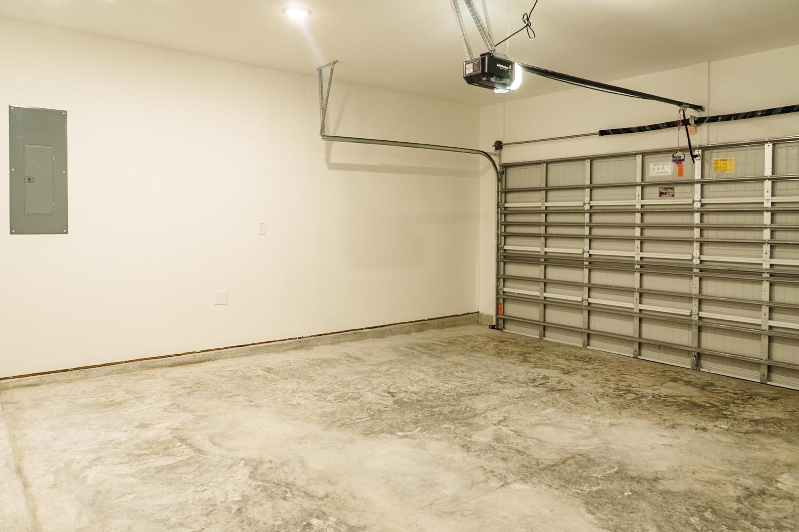 2306 Ridgewood Drive Drive, West Columbia, TX 77486 Spacious, well-lit garage with a durable concrete floor and automatic door opener, perfect for storage or parking.