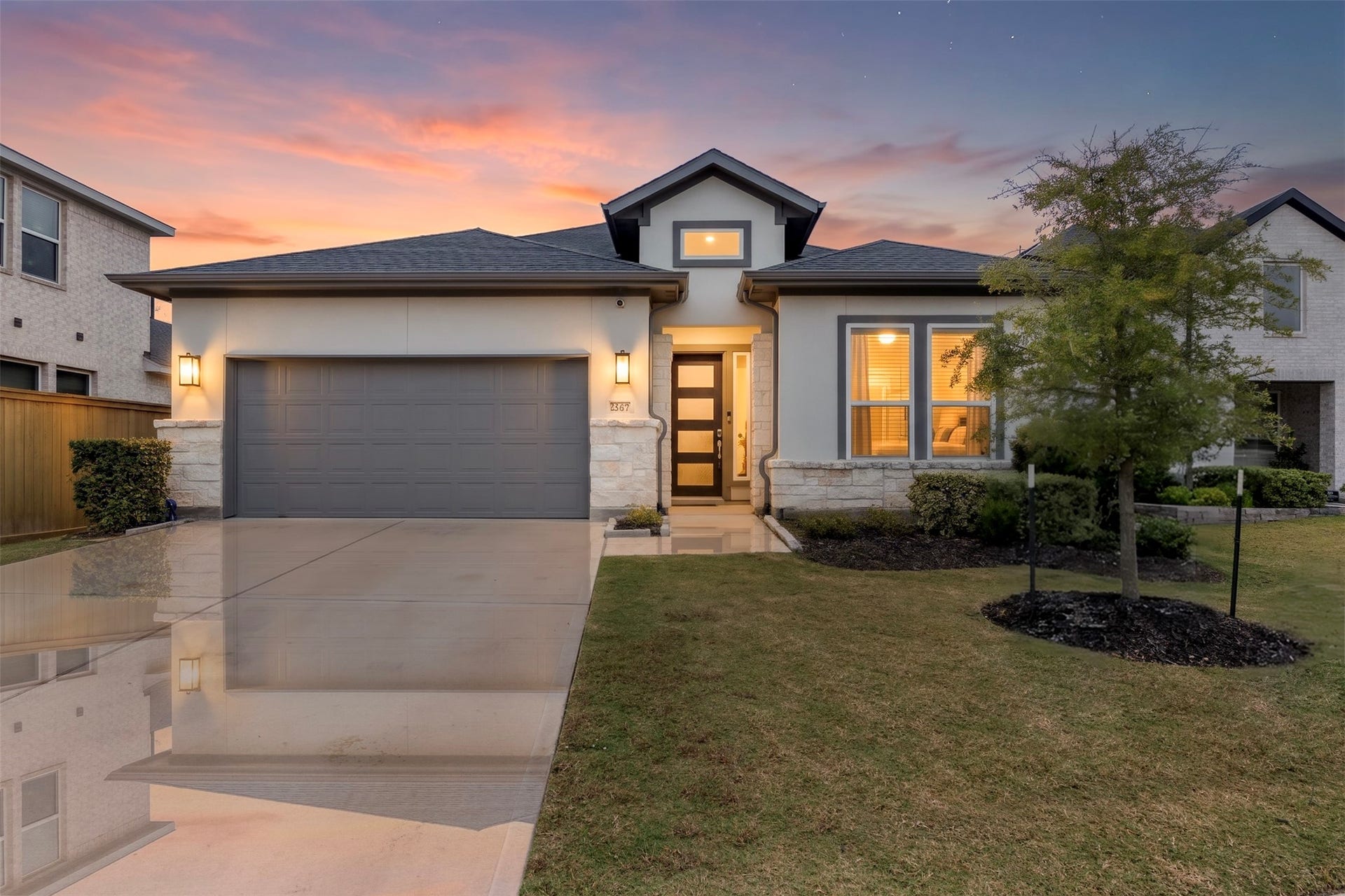 22107 Palo Dura Lane, Tomball, TX 77375 Elegant home with a warm, inviting facade and beautifully landscaped front yard.