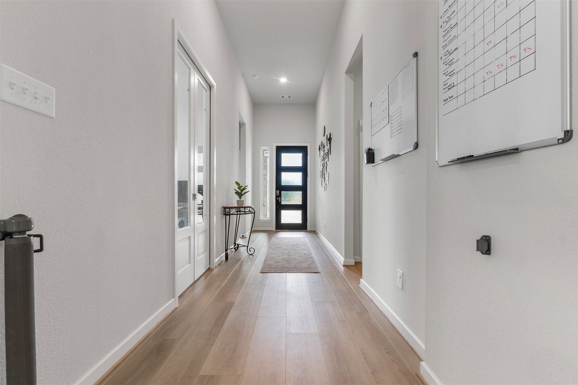 22107 Palo Dura Lane, Tomball, TX 77375 Bright and inviting hallway with sleek hardwood floors, and modern front door.
