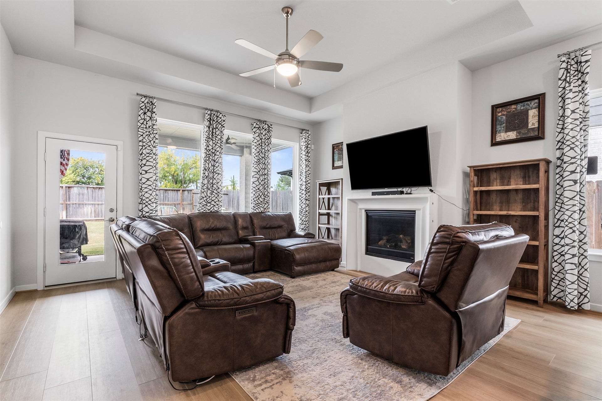 22107 Palo Dura Lane, Tomball, TX 77375 The adjoining living space offers ample seating, natural light, and a cozy fireplace, perfect for entertaining.