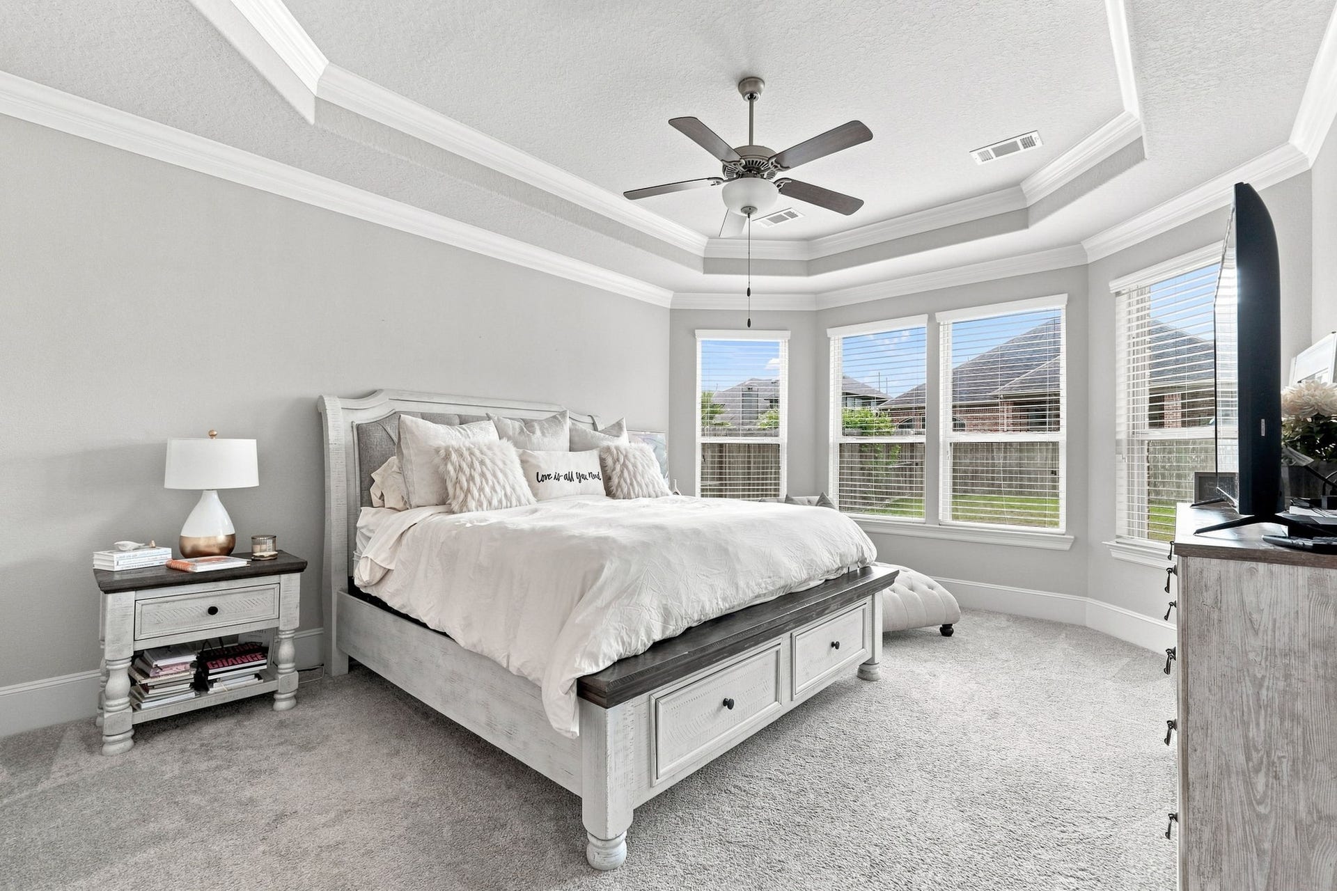 30719 Barred Owl Way, Fulshear, TX 77423 The spacious primary suite offers a beautiful retreat with a tray ceiling and elegant crown molding.