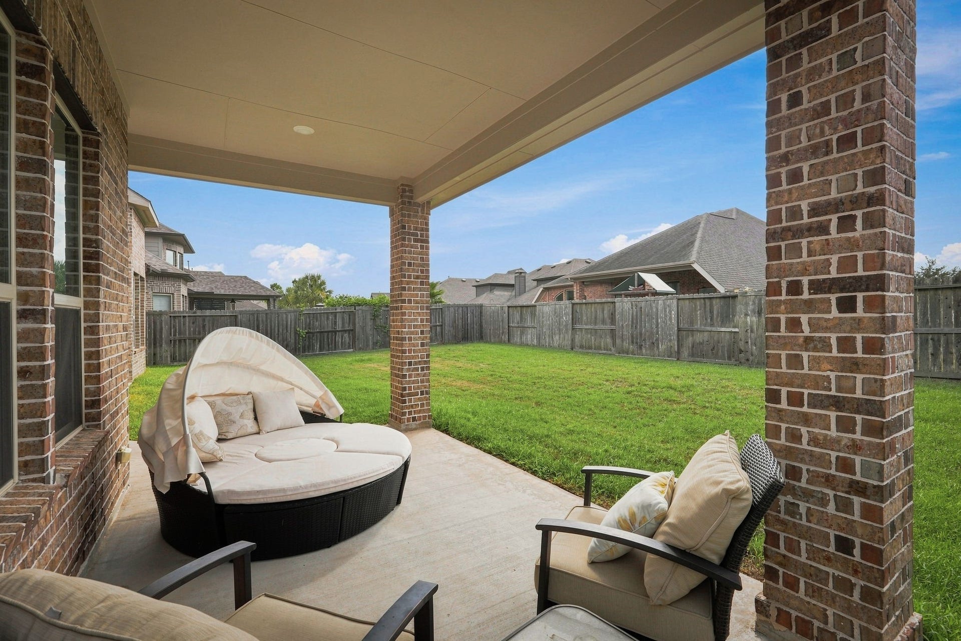 30719 Barred Owl Way, Fulshear, TX 77423 The covered patio offers a shaded setting for relaxing or dining outdoors.
