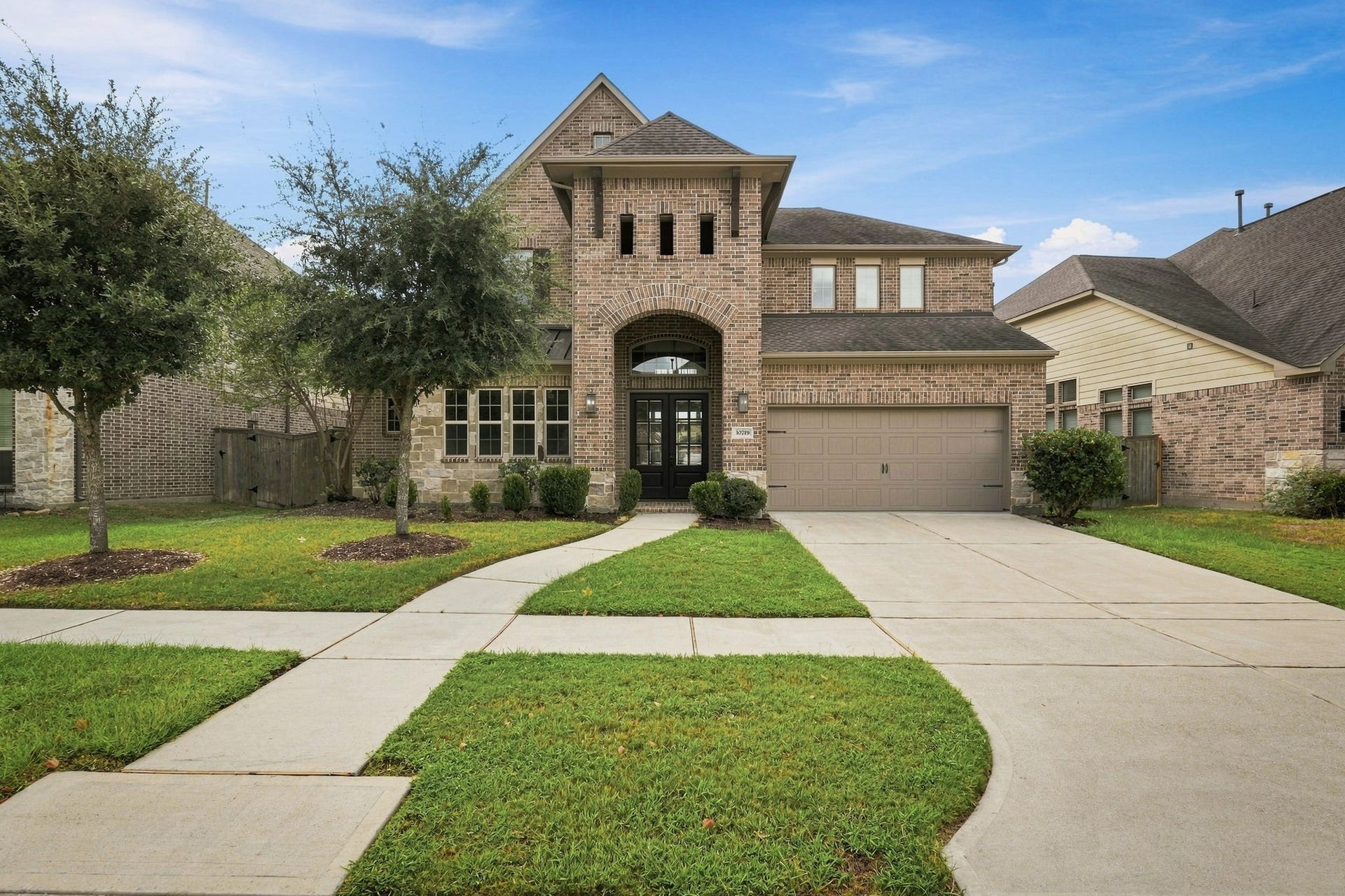 30719 Barred Owl Way, Fulshear, TX 77423 The attached garage provides convenient parking and additional space for storage.