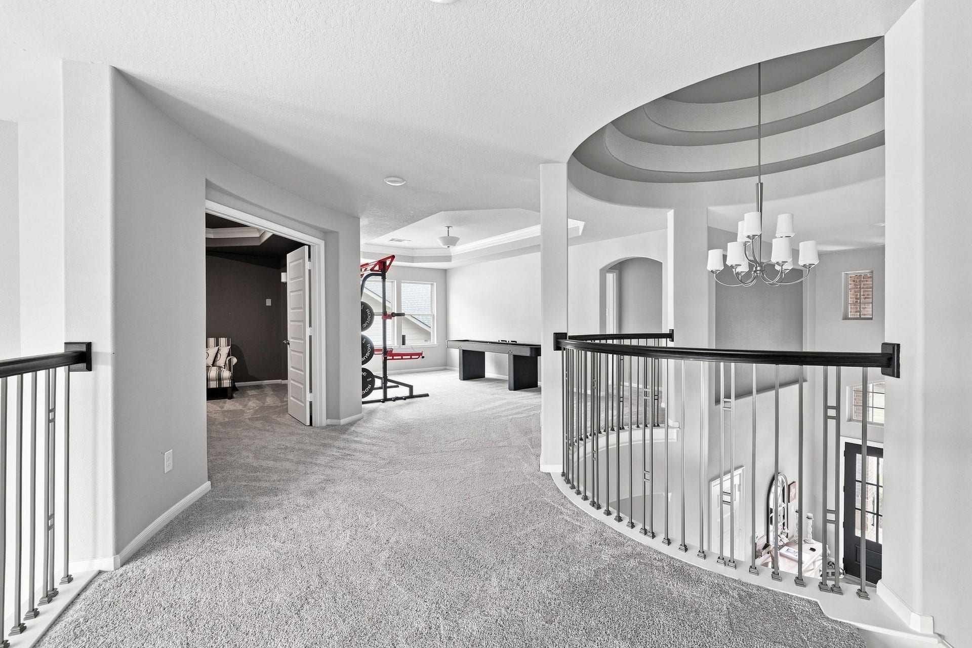 30719 Barred Owl Way, Fulshear, TX 77423 A thoughtfully designed transition between the upstairs bedrooms, game room, and media room, with beautiful views of the homes impressive interior.