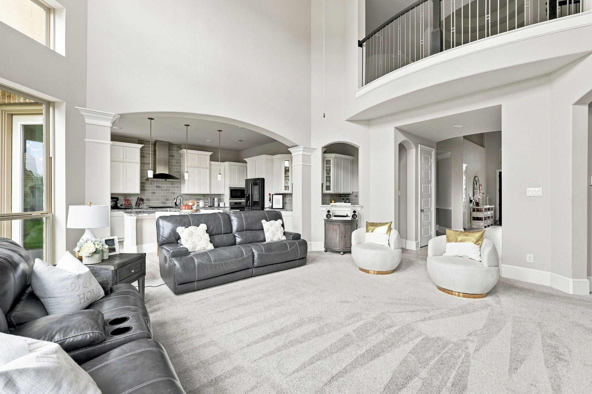30719 Barred Owl Way, Fulshear, TX 77423 The dramatic ceiling height and open upper balcony add an extraordinary sense of scale.