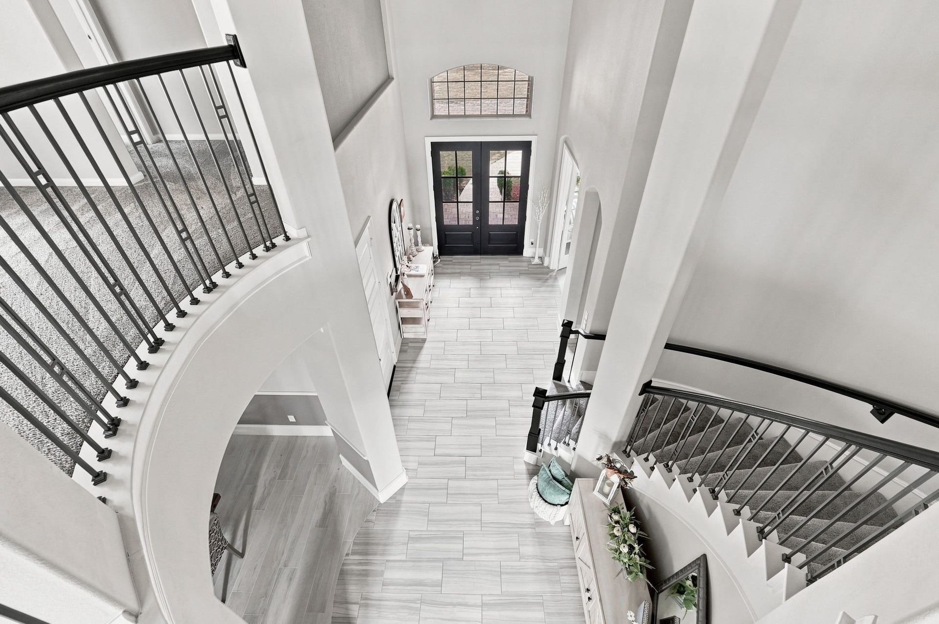 30719 Barred Owl Way, Fulshear, TX 77423 A sweeping staircase, curved upper balcony, and dramatic circular ceiling detail create an unforgettable welcome.