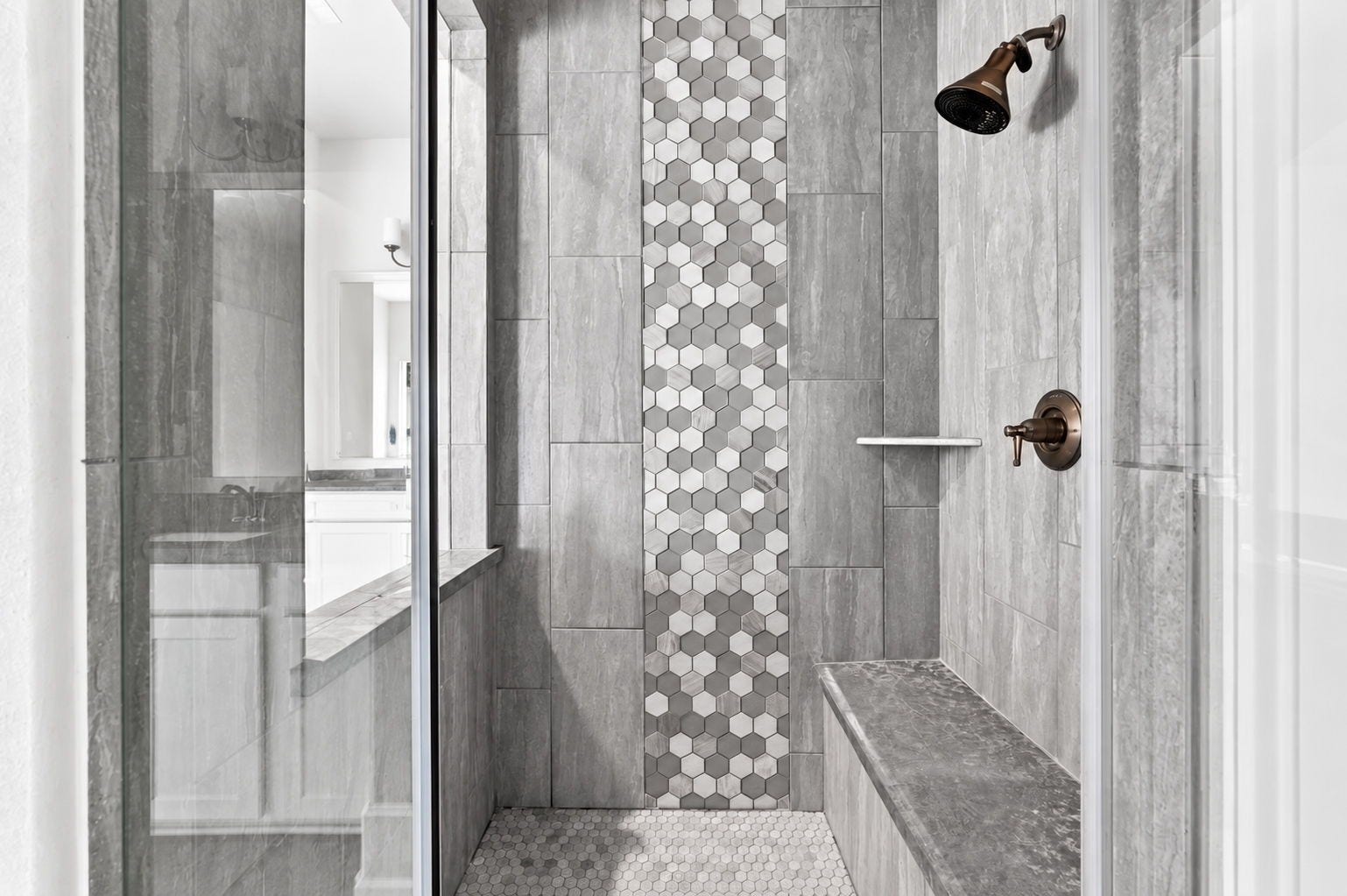 30719 Barred Owl Way, Fulshear, TX 77423 A spacious walk-in shower features beautiful tile detailing and a glass enclosure.
