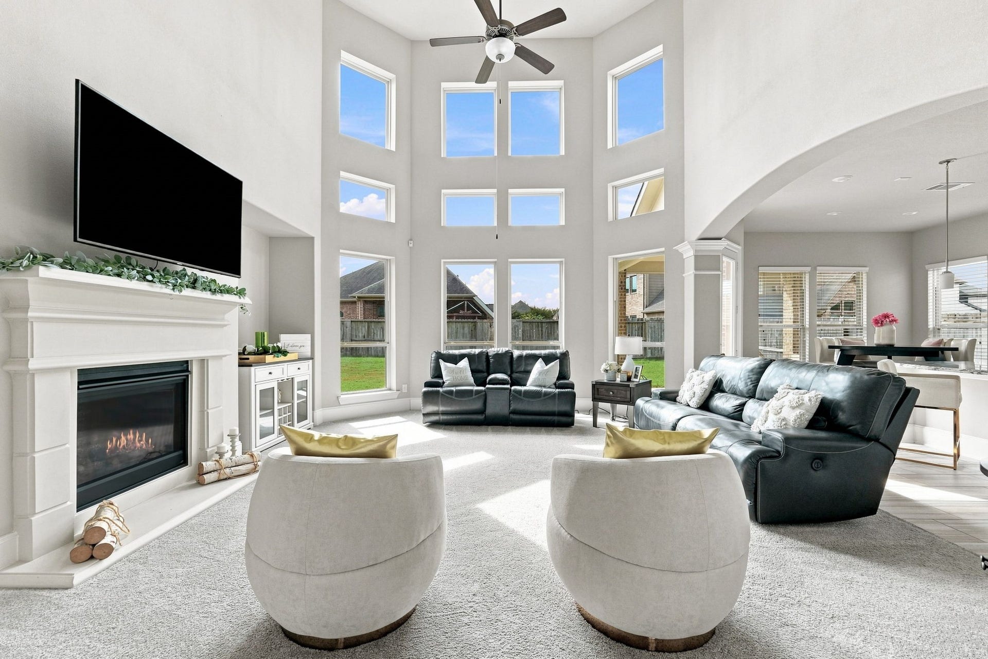 30719 Barred Owl Way, Fulshear, TX 77423 The grand living room is an architectural showpiece, featuring a breathtaking wall of windows that fills the space with natural light.