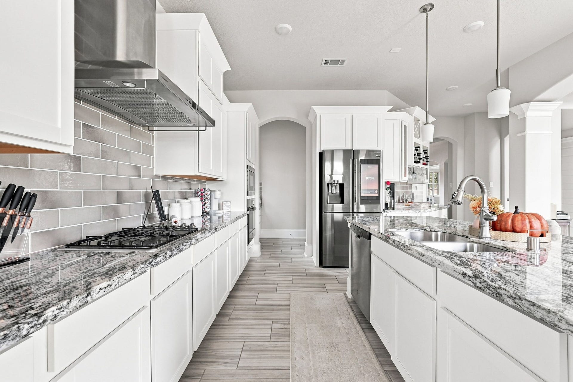 30719 Barred Owl Way, Fulshear, TX 77423 Pendant lighting and abundant cabinetry complete this impressive kitchen, designed for both everyday meals and entertaining.