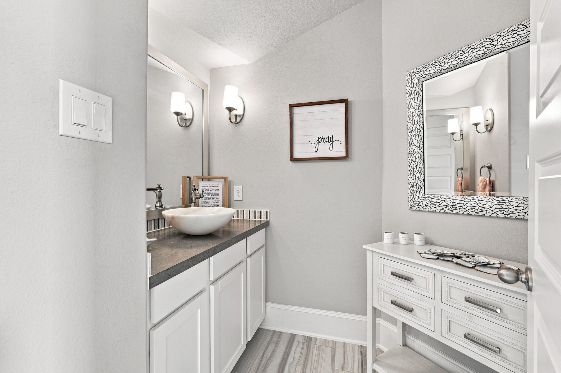 30719 Barred Owl Way, Fulshear, TX 77423 A beautifully appointed guest bathroom provides a welcoming space for visitors.