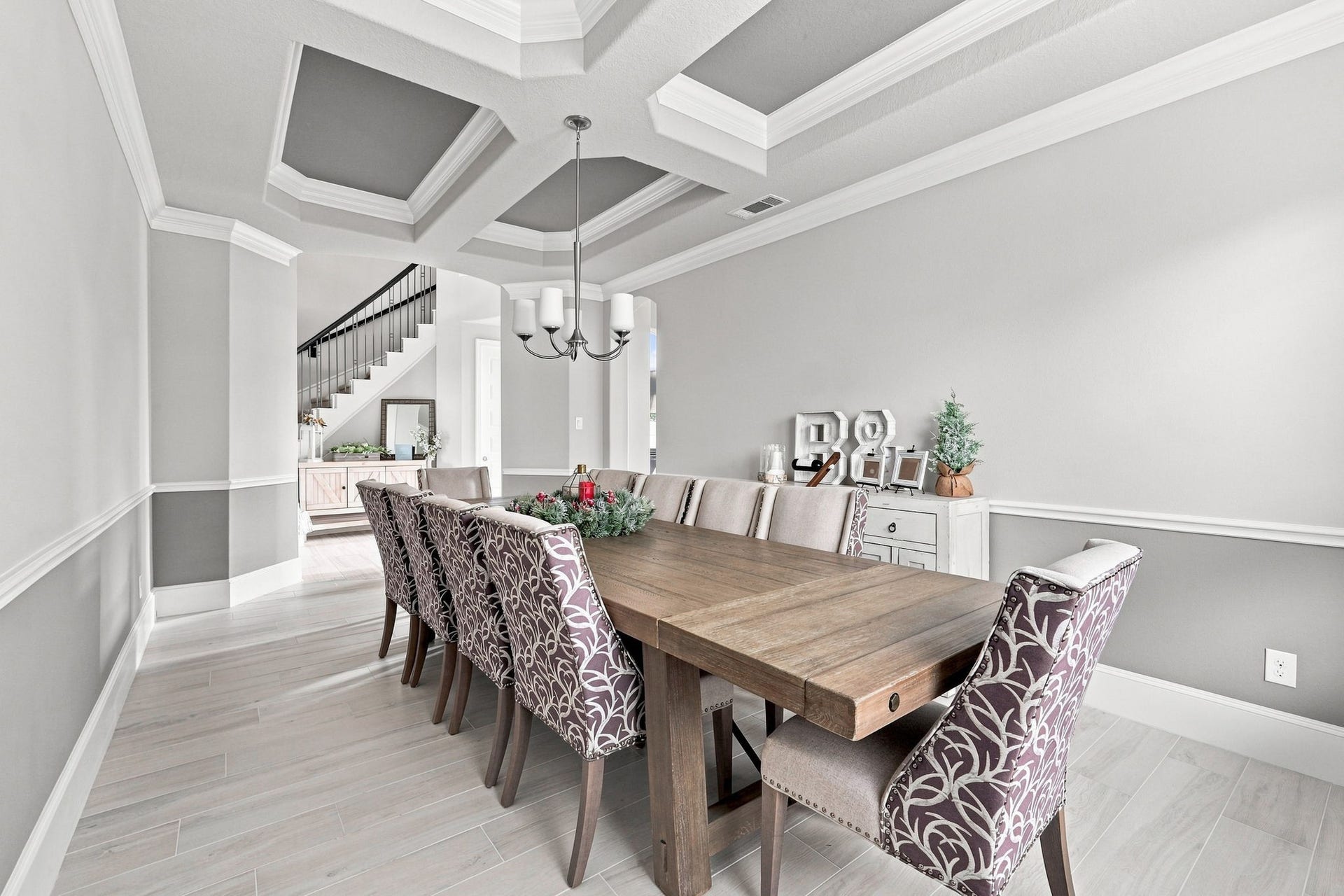 30719 Barred Owl Way, Fulshear, TX 77423 The formal dining room makes a sophisticated statement with its exquisite coffered ceiling and elegant chandelier.