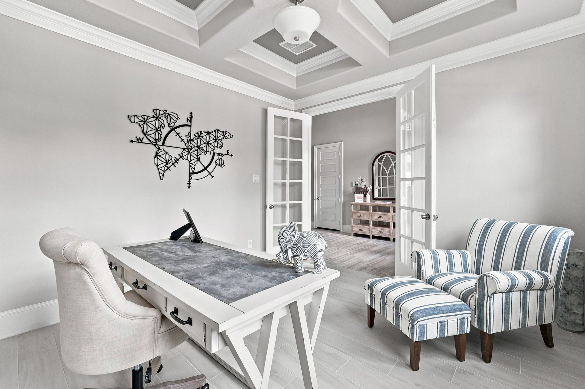 30719 Barred Owl Way, Fulshear, TX 77423 Multiple windows, crown molding, and an elegant coffered ceiling elevate this thoughtfully designed space.