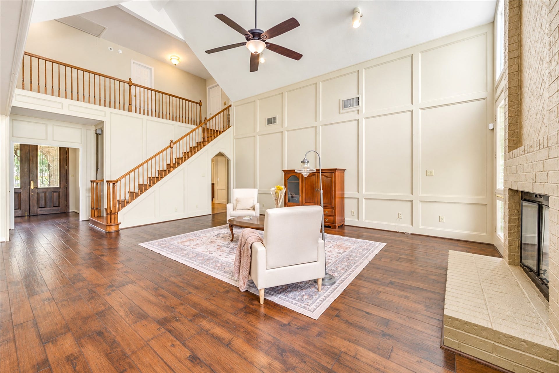 The living room is open to the dining, kitchen and has a view of the upstairs.