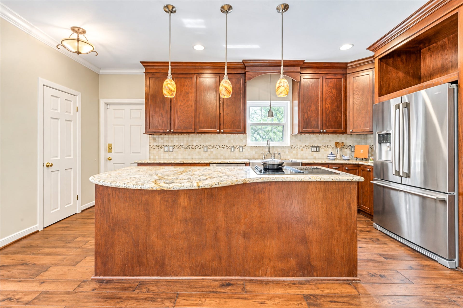 Just off the kitchen is the half bath, and three car garage.