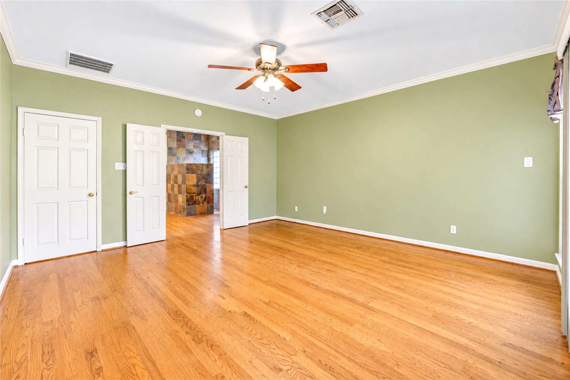 Another view of the primary bedroom.
