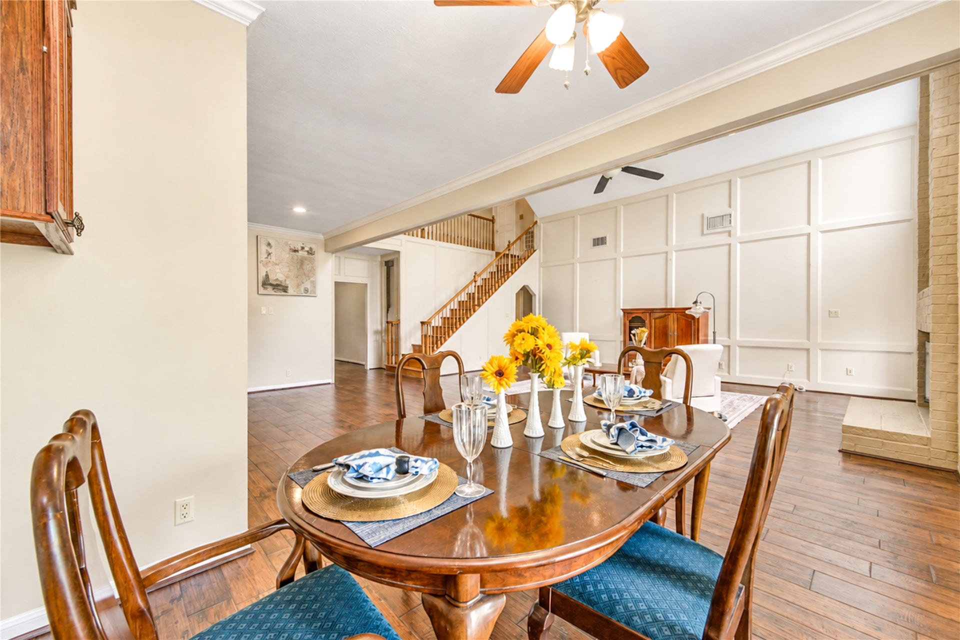 The dining space opens to the bright living area and is accompanied by large windows.