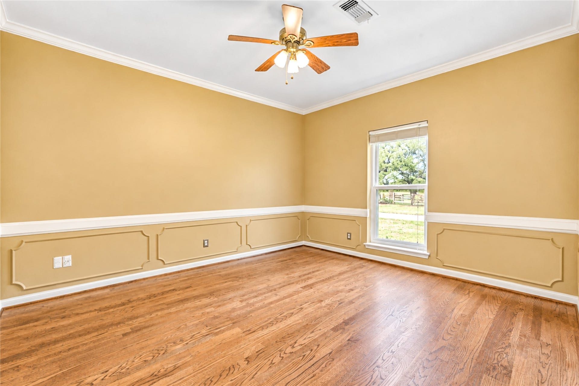 In the front of the home, off the entryway and kitchen, you will find the large office that features wainscoting and warm wood-look flooring.