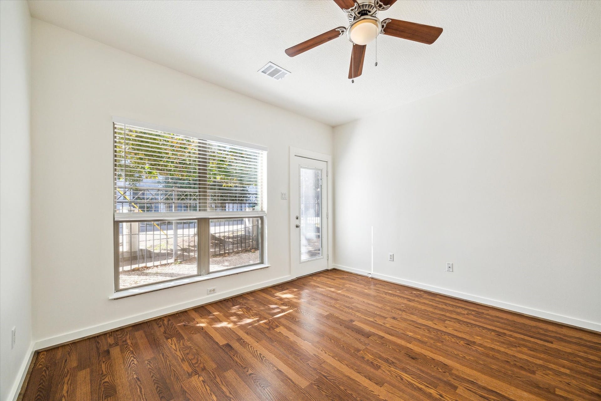 4046 Center Street, Houston, TX 77007 First floor bedroom with recently installed laminate flooring.