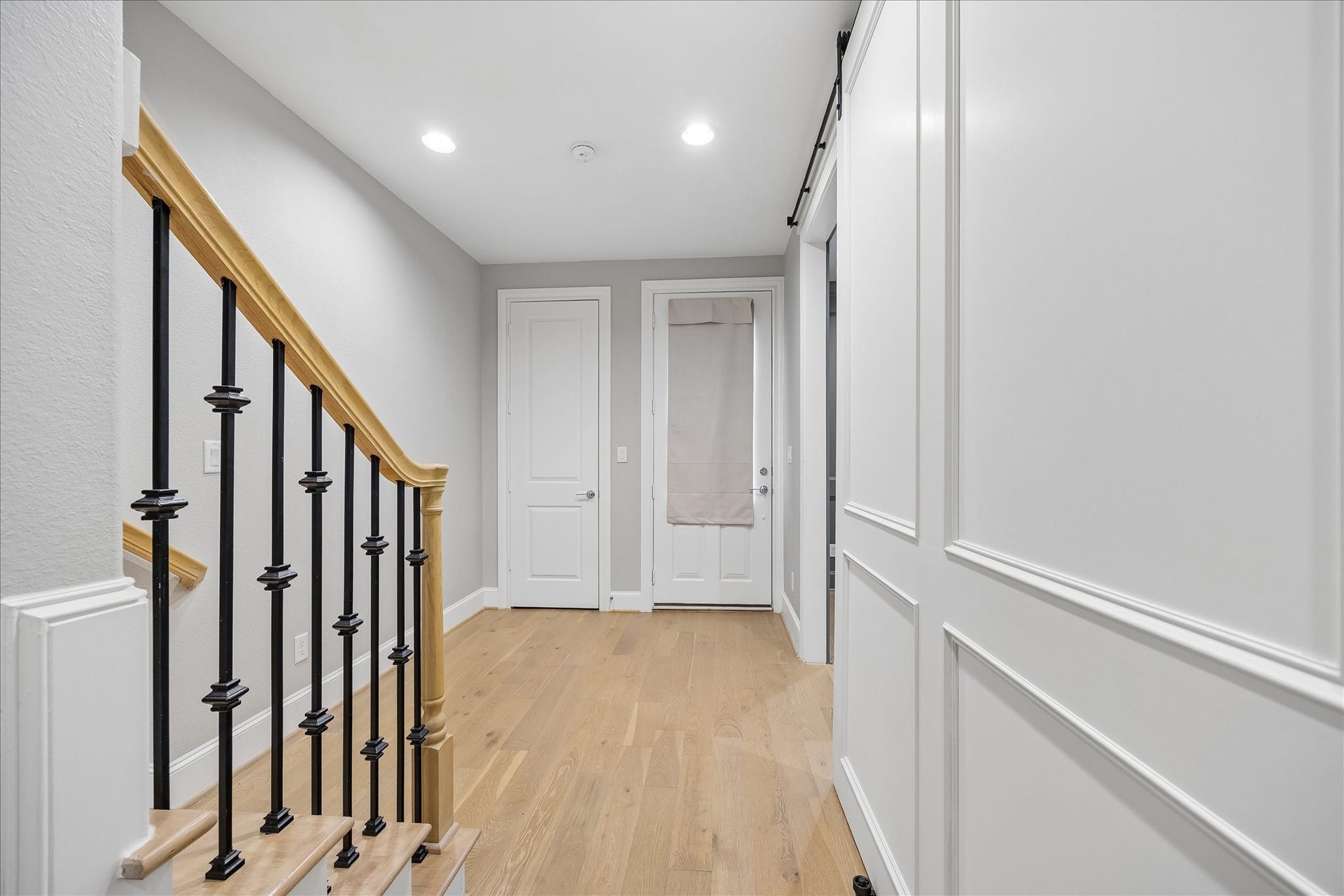 6029 Matthew Oaks Place, Houston, TX 77007 Bright and inviting entryway featuring elegant wood flooring, stylish railing, and modern finishes with large coat closet.
