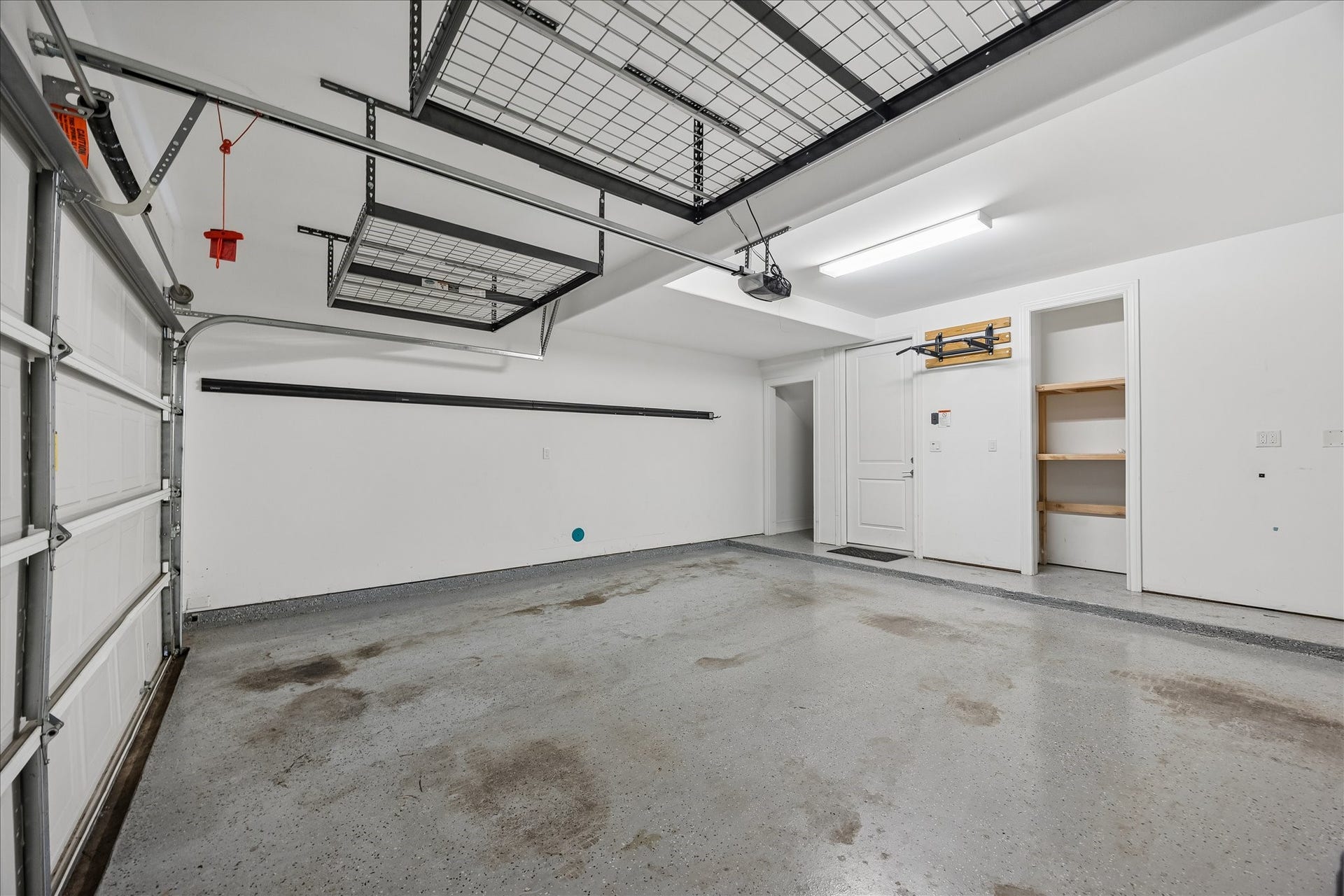 6029 Matthew Oaks Place, Houston, TX 77007 Spacious and clean garage featuring ample storage shelves, overhead racks, and convenient interior access.