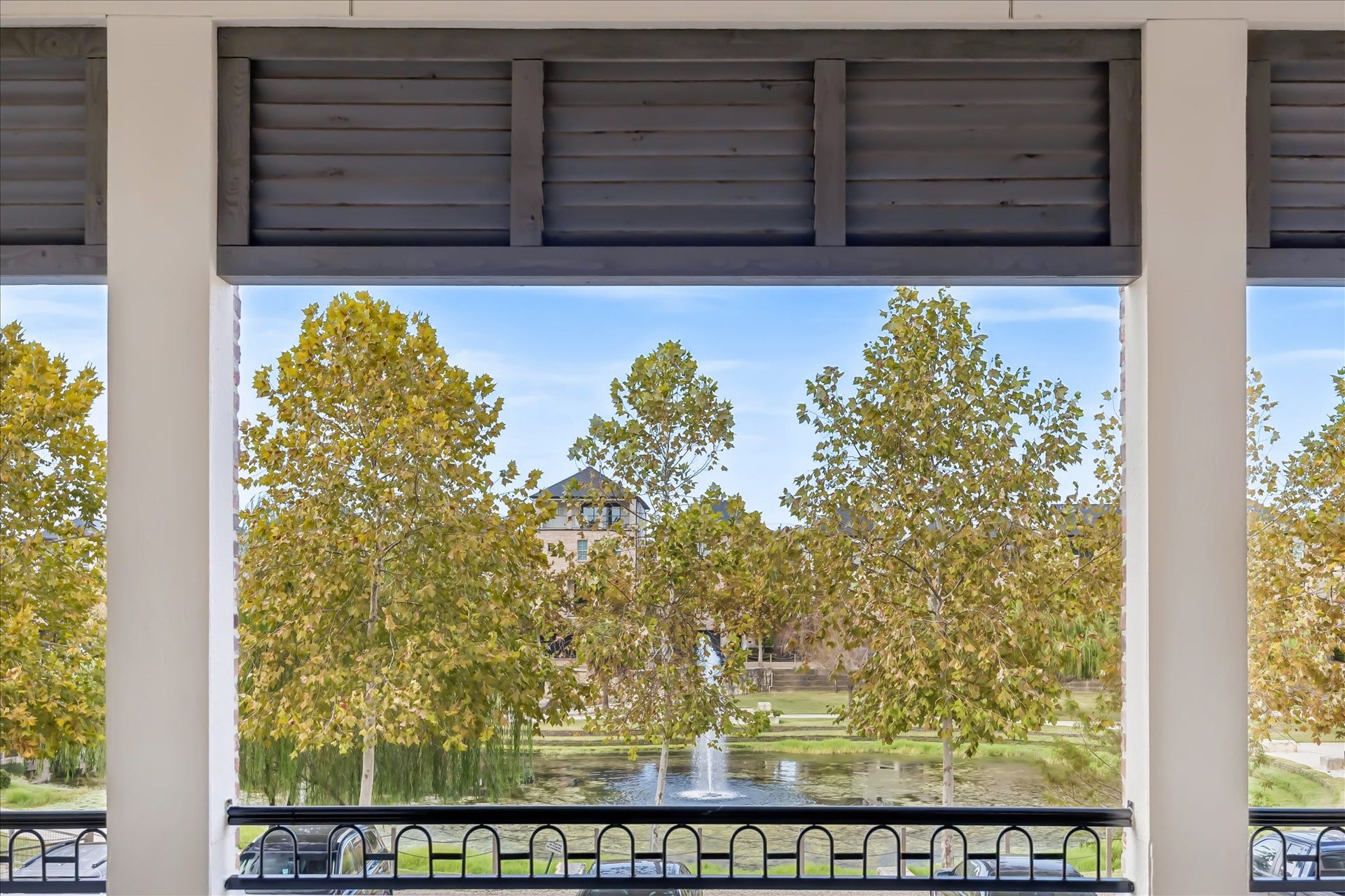 6029 Matthew Oaks Place, Houston, TX 77007 Enjoy serene views of lush trees and a tranquil pond with fountain water feature from the comfort of your spacious living area and balcony.