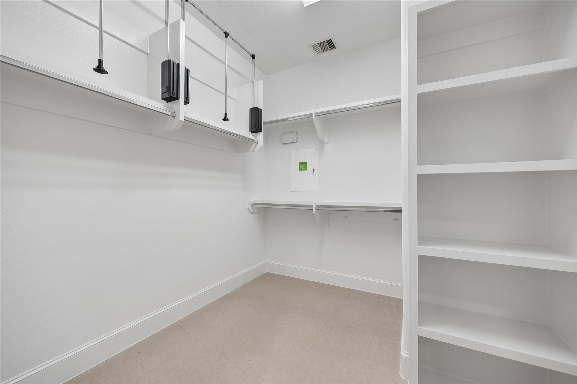 6029 Matthew Oaks Place, Houston, TX 77007 Spacious walk-in closet featuring built-in shelving and ample hanging space, perfect for organized storage.