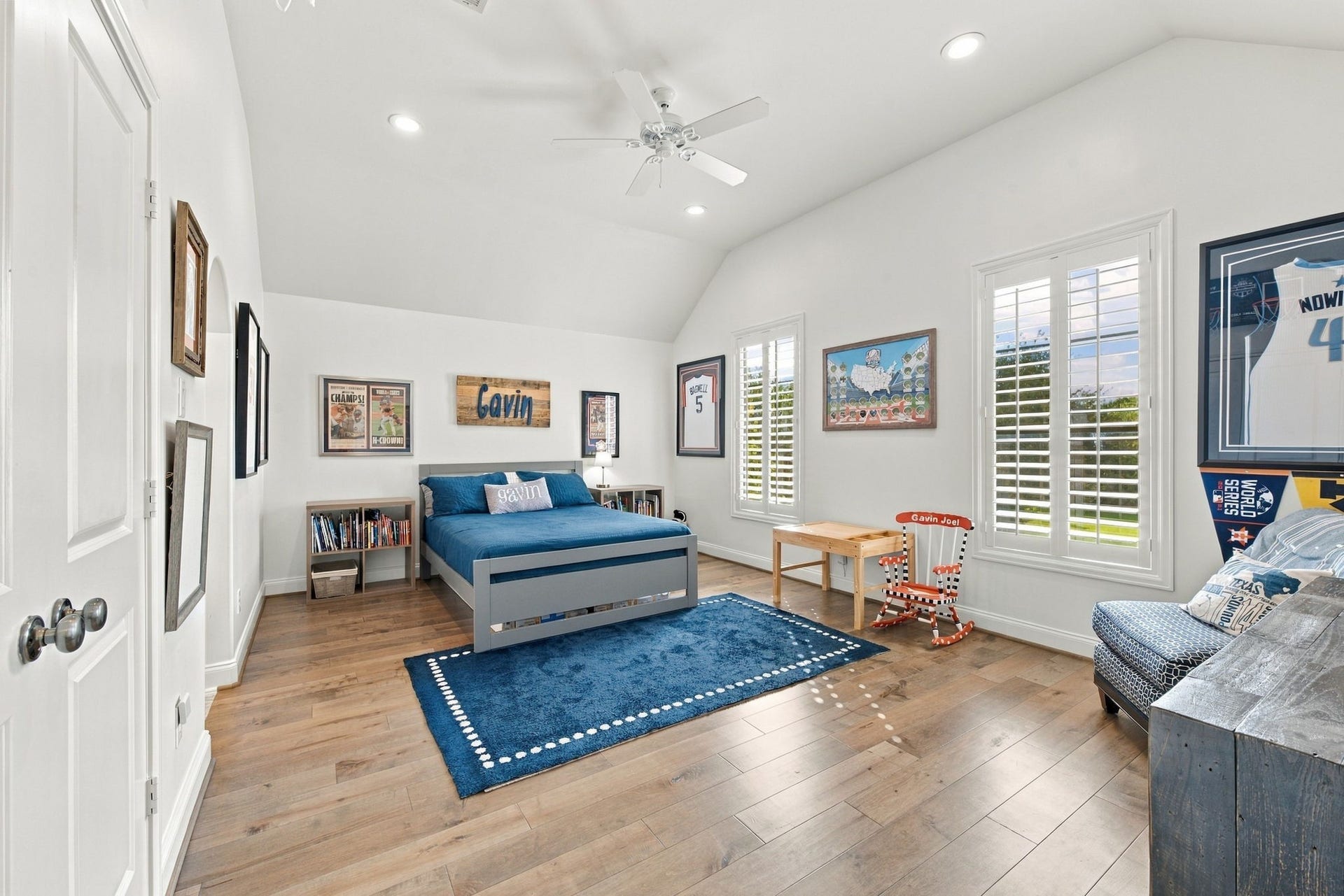 Spacious secondary bedroom featuring vaulted ceilings, hardwood floors, recessed lighting, ceiling fan & plantation shutters. Wonderful natural light & plenty of room for a sitting or study area.