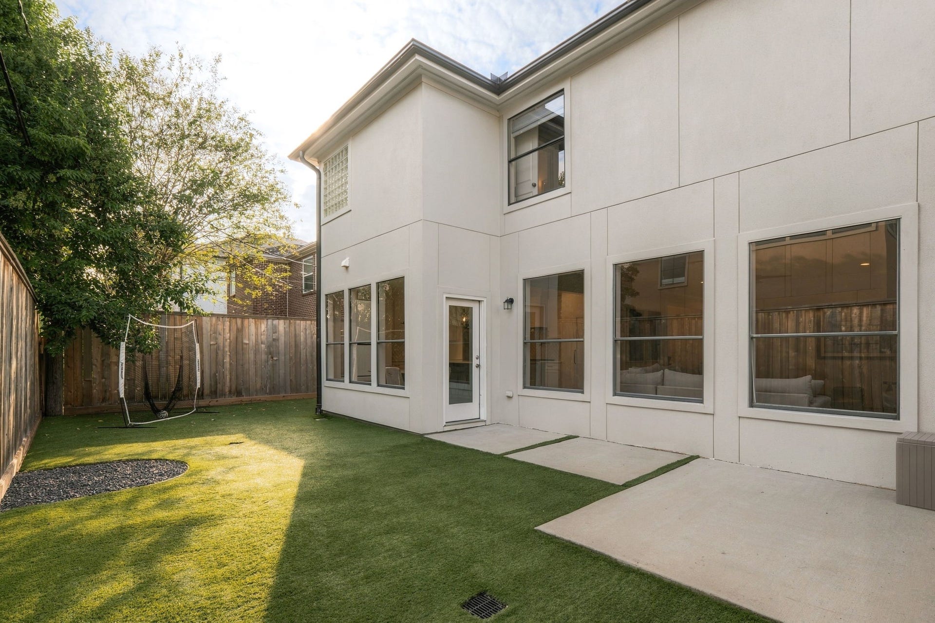 Beautiful backyard featuring low-maintenance turf, nice patio area & mature trees, all surrounded by wood fencing. Large windows along the rear of the home overlook the outdoor space, creating a wonderful connection between indoor & outdoor living.
